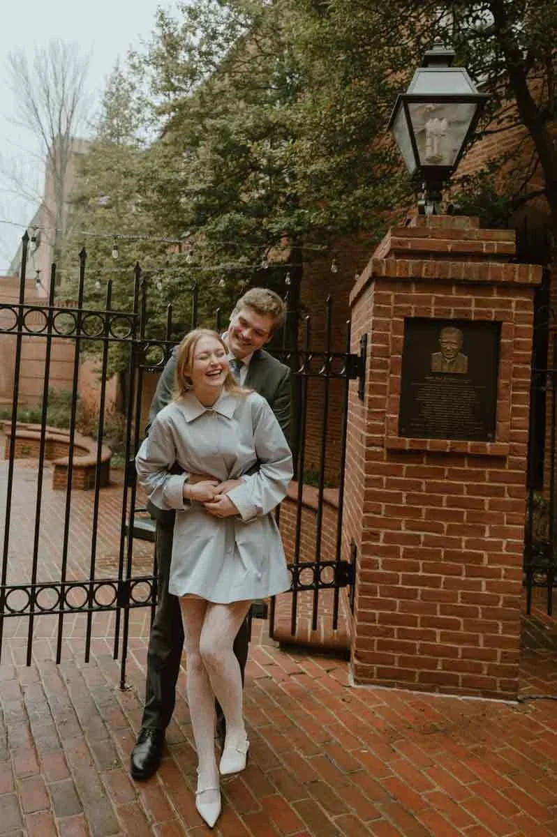 Bride and groom posing in downtown Lancaster PA on a rainy wedding day