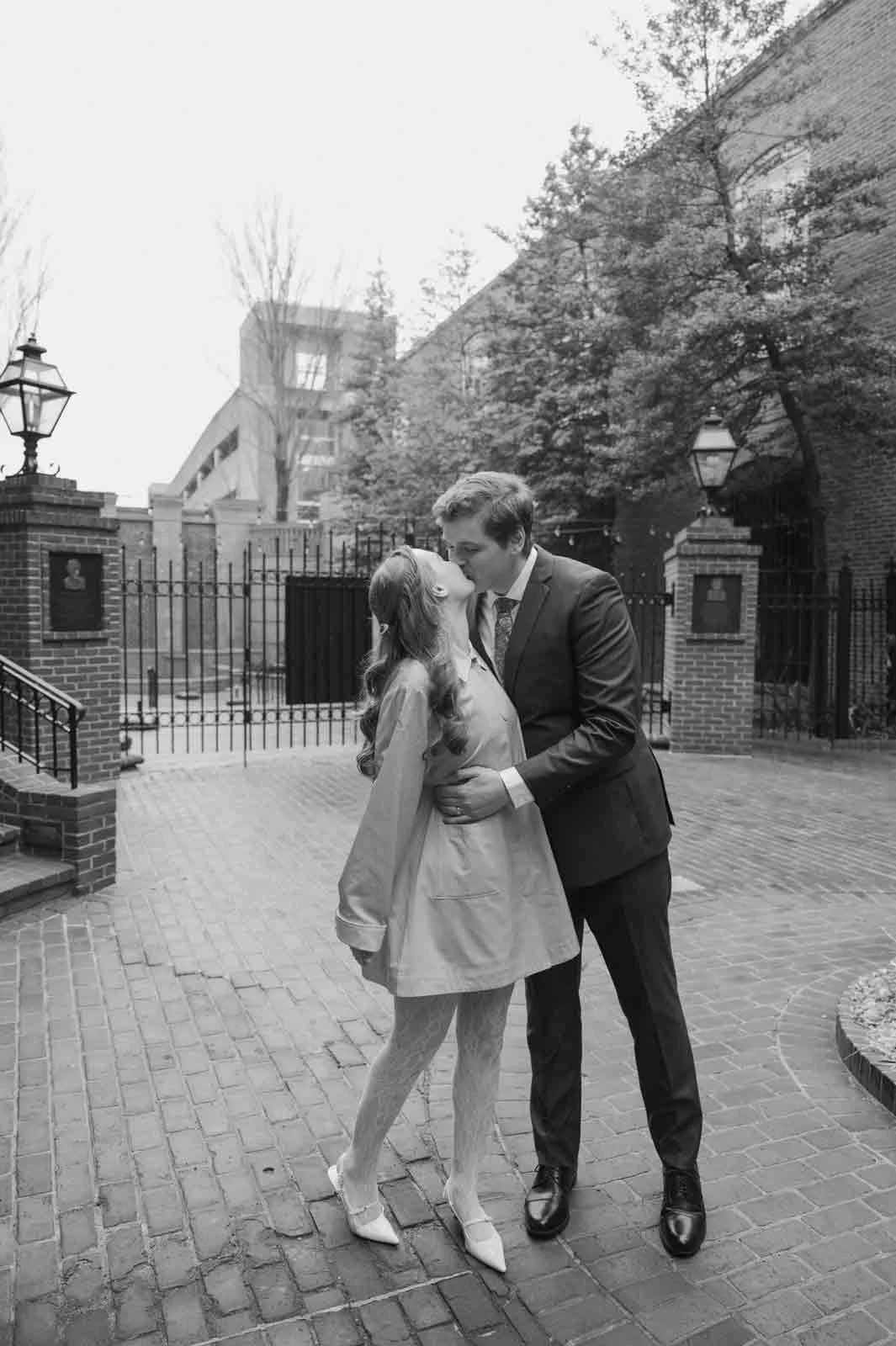 Bride wearing vintage blue raincoat during downtown Lancaster couples photos