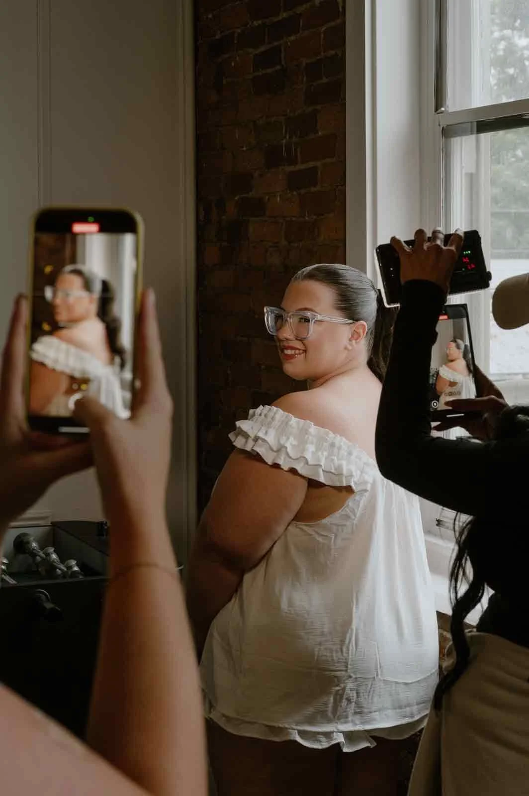 candid bridal portrait after finishing wedding hair and makeup at Iron Front in Lewisburg