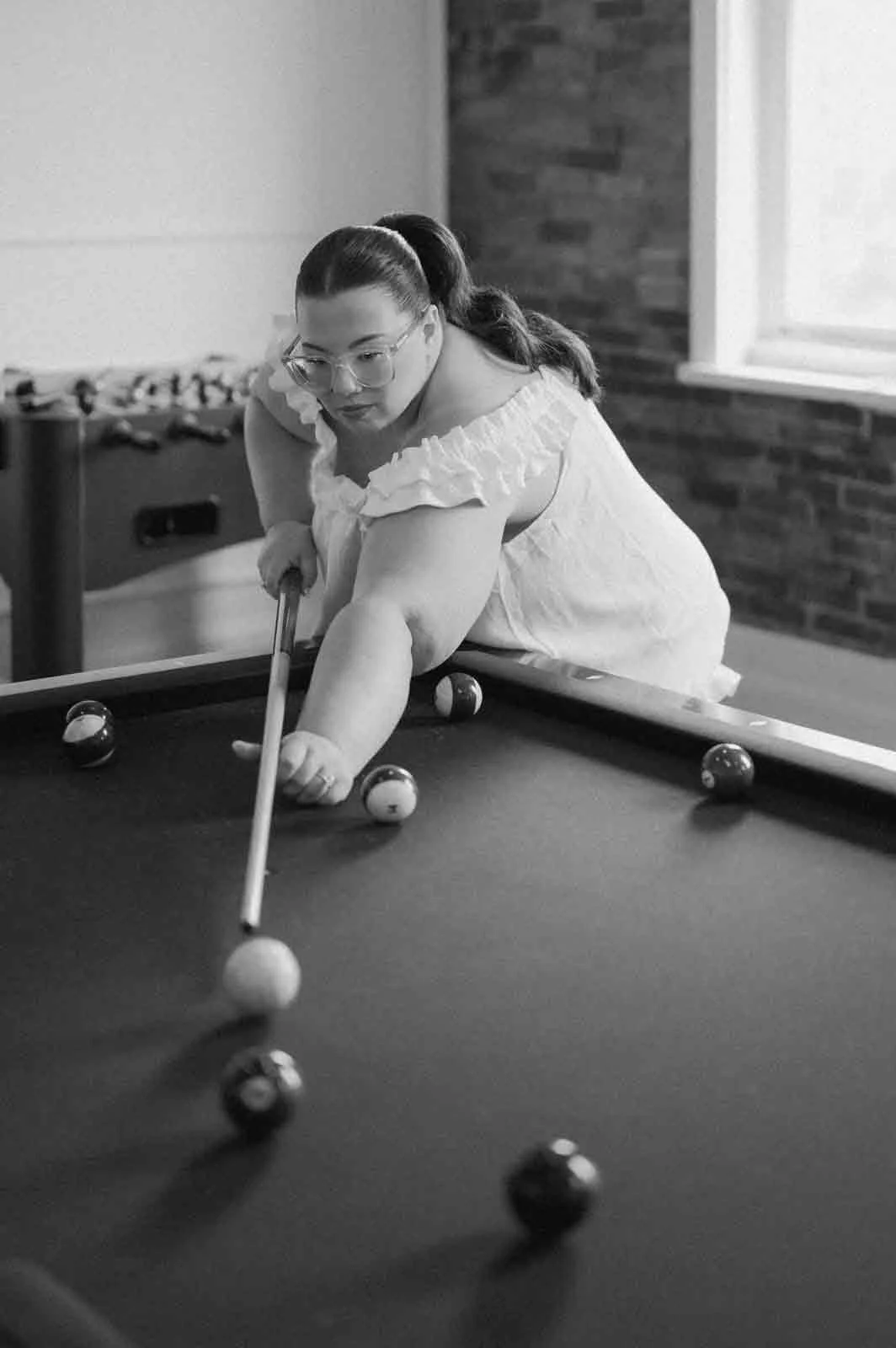 bride playing pool during morning of wedding in Lewisburg