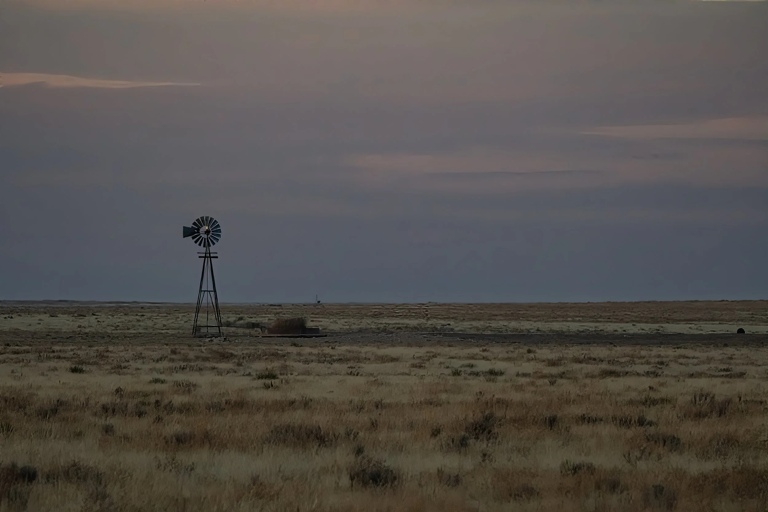 WEST TEXAS WINDMILL – Evening shadows drape over the flatlands of the Texas panhandle.