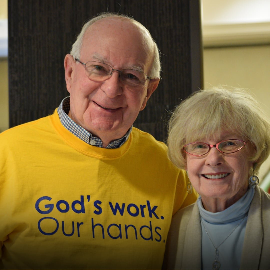 Smiling elderly man & woman.