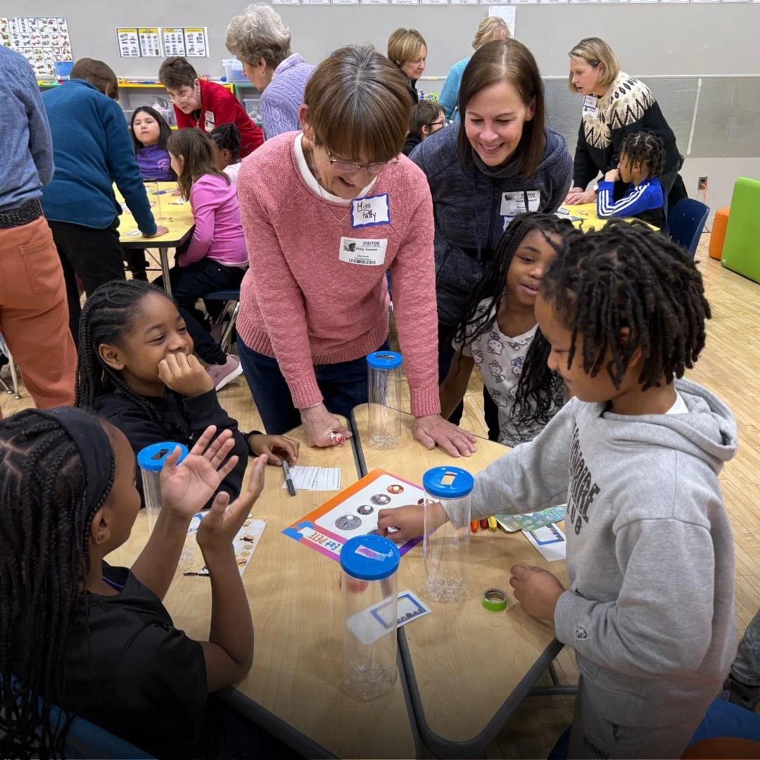 Volunteers serving at a local school by leading students through a fun activity.