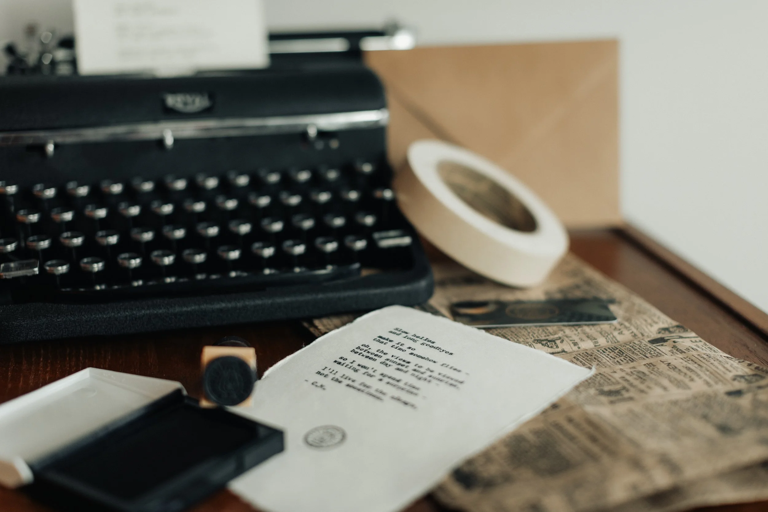 A typewritten poem and lantern-insignia stamp beside a Royal typewriter.