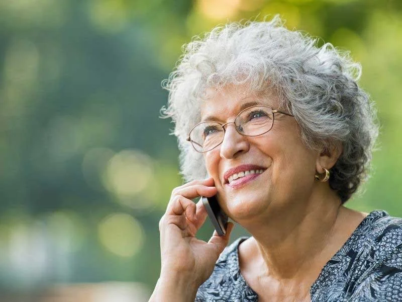 Woman on the phone with insurance agent asking about open enrollment