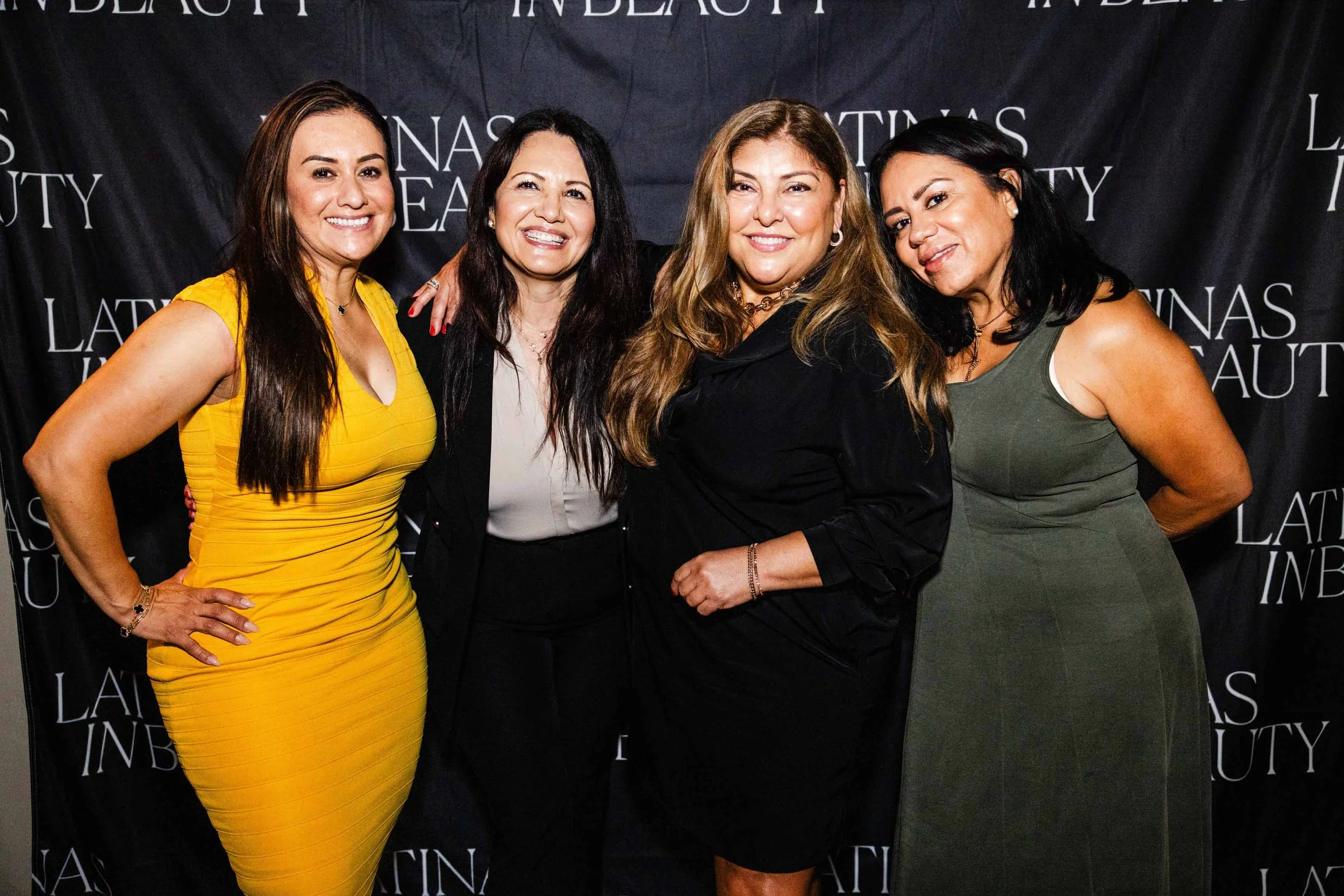 Smiling women stand together at the Latinas in Beauty event red carpet, captured as part of nonprofit event photography in Los Angeles.