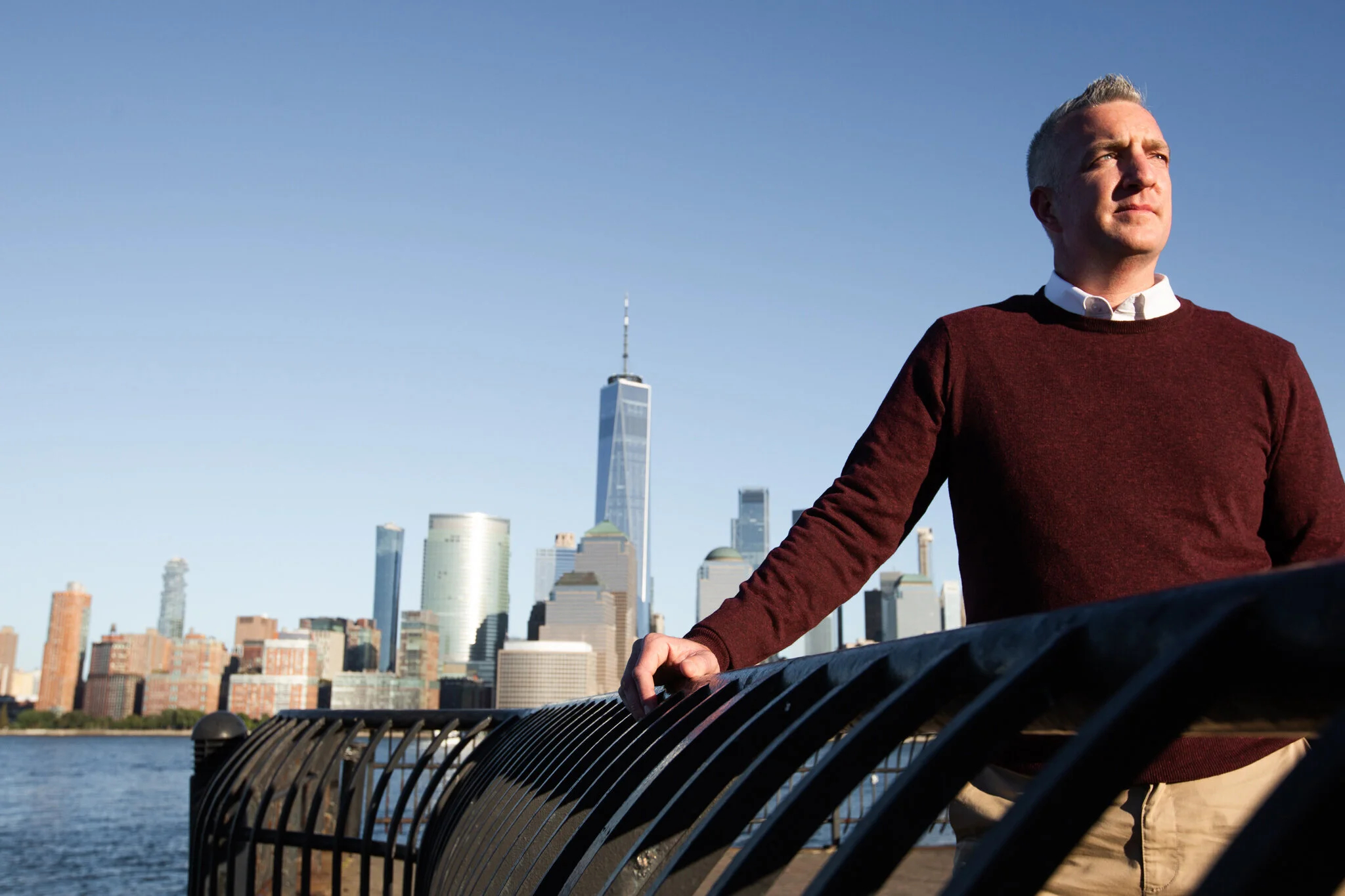 A man by the waterfront in Jersey City in this New Jersey branding photography session