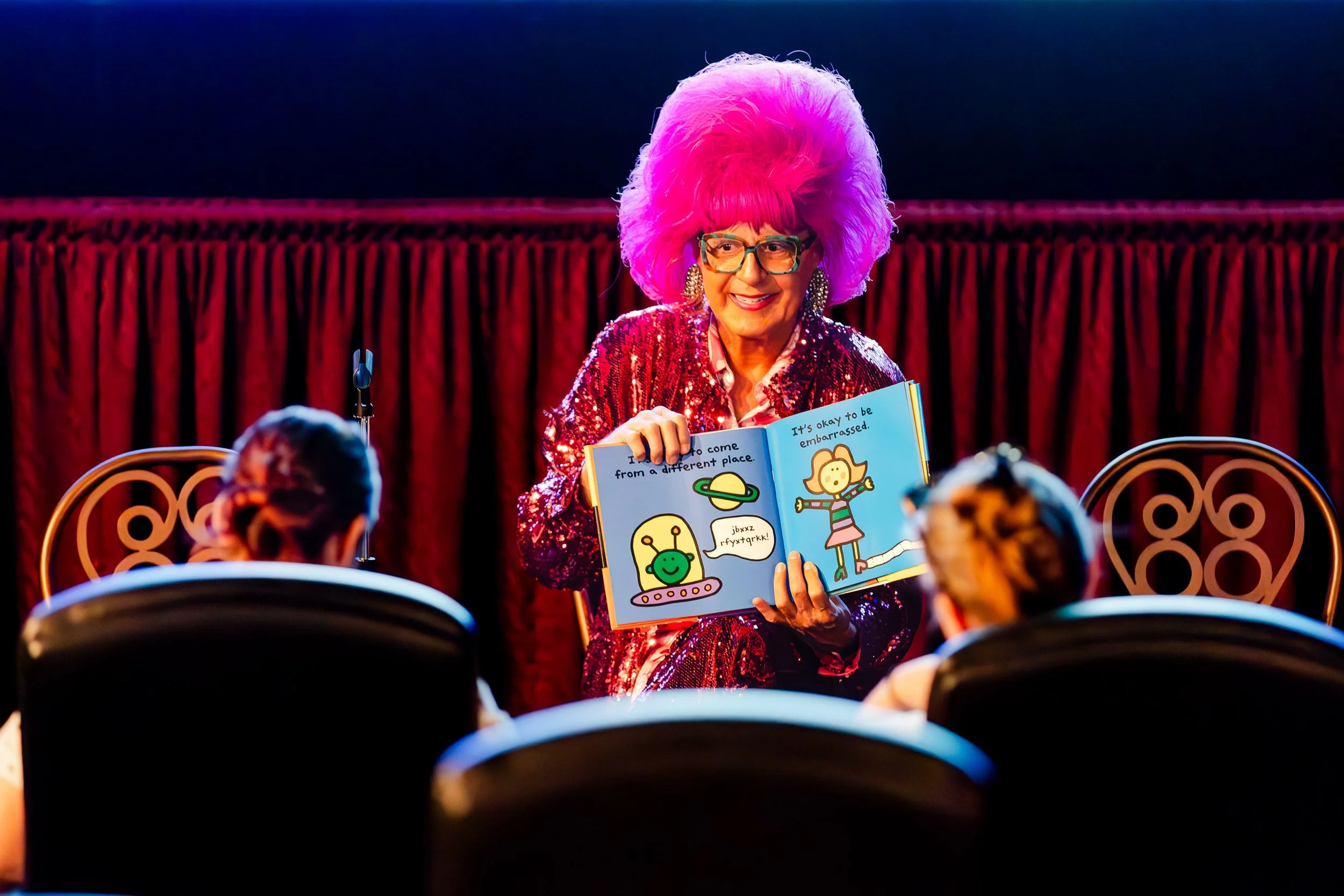 Drag performer reading a children’s book during a family storytelling session at Palm Springs Book Fest.