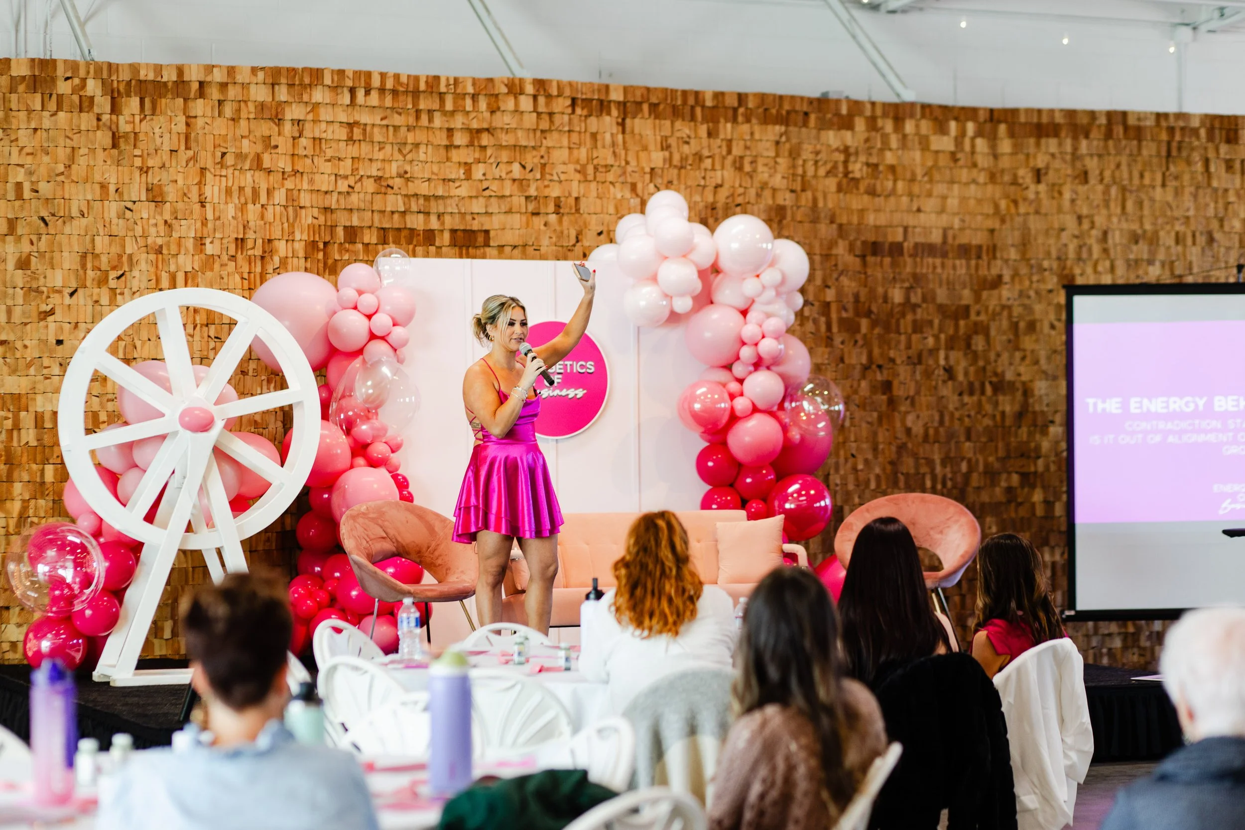 Female keynote speaker presenting at Energetics of Business event