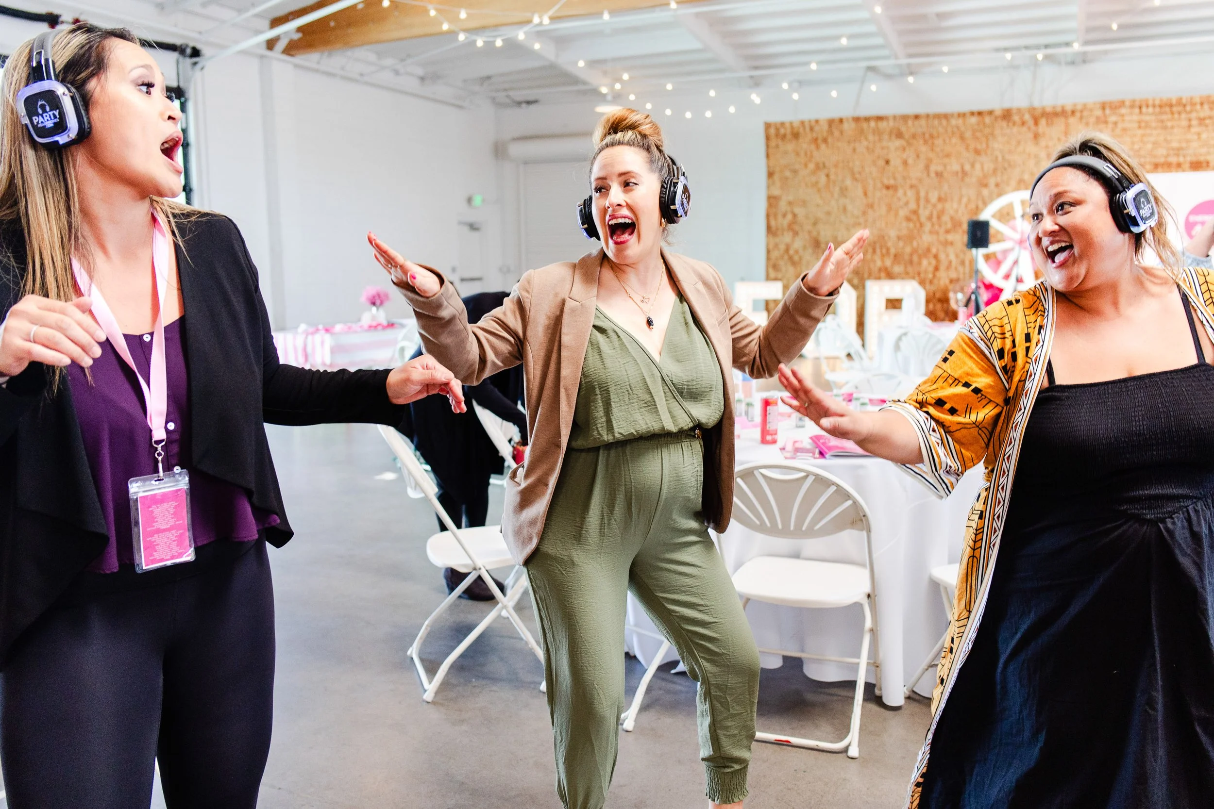 Women dancing and celebrating at transformational business retreat