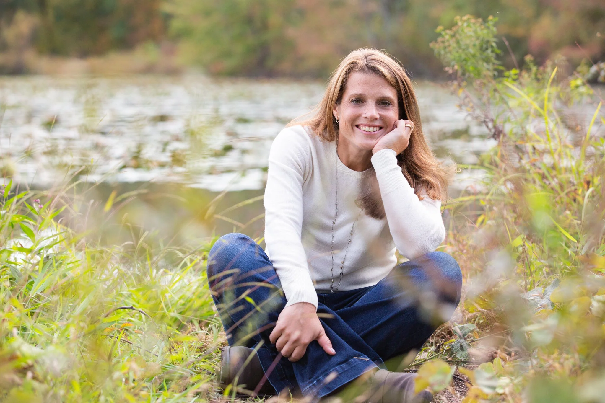Brand photo of woman sitting cross-legged on the trail at Great Swamp, captured during a wellness-focused brand session in New Jersey