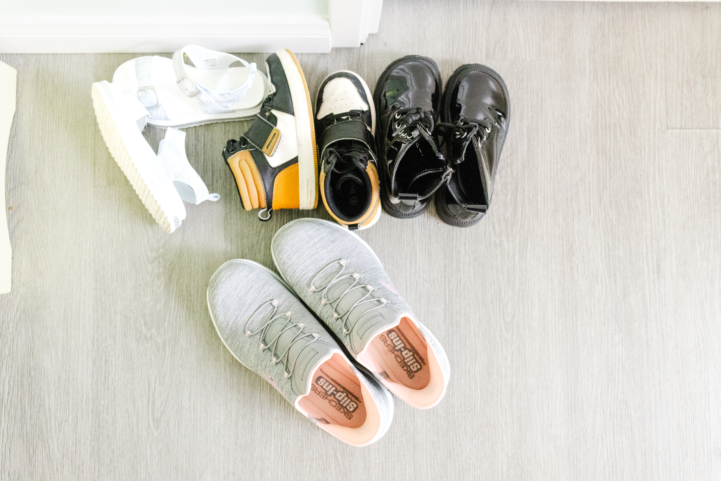 A group of shoes are gathered by the door of an LMFT's office during a brand photo shoot for a therapist.