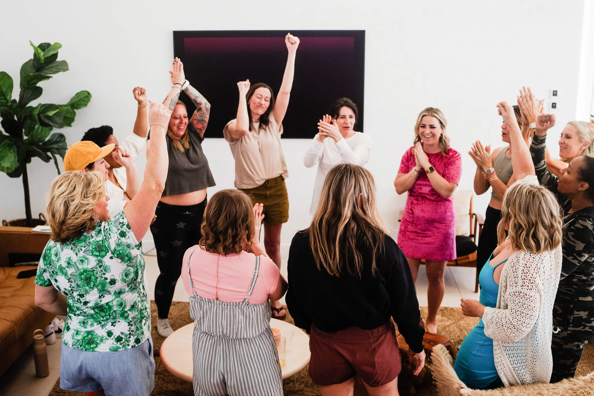A group of women celebrates at a business retreat.
