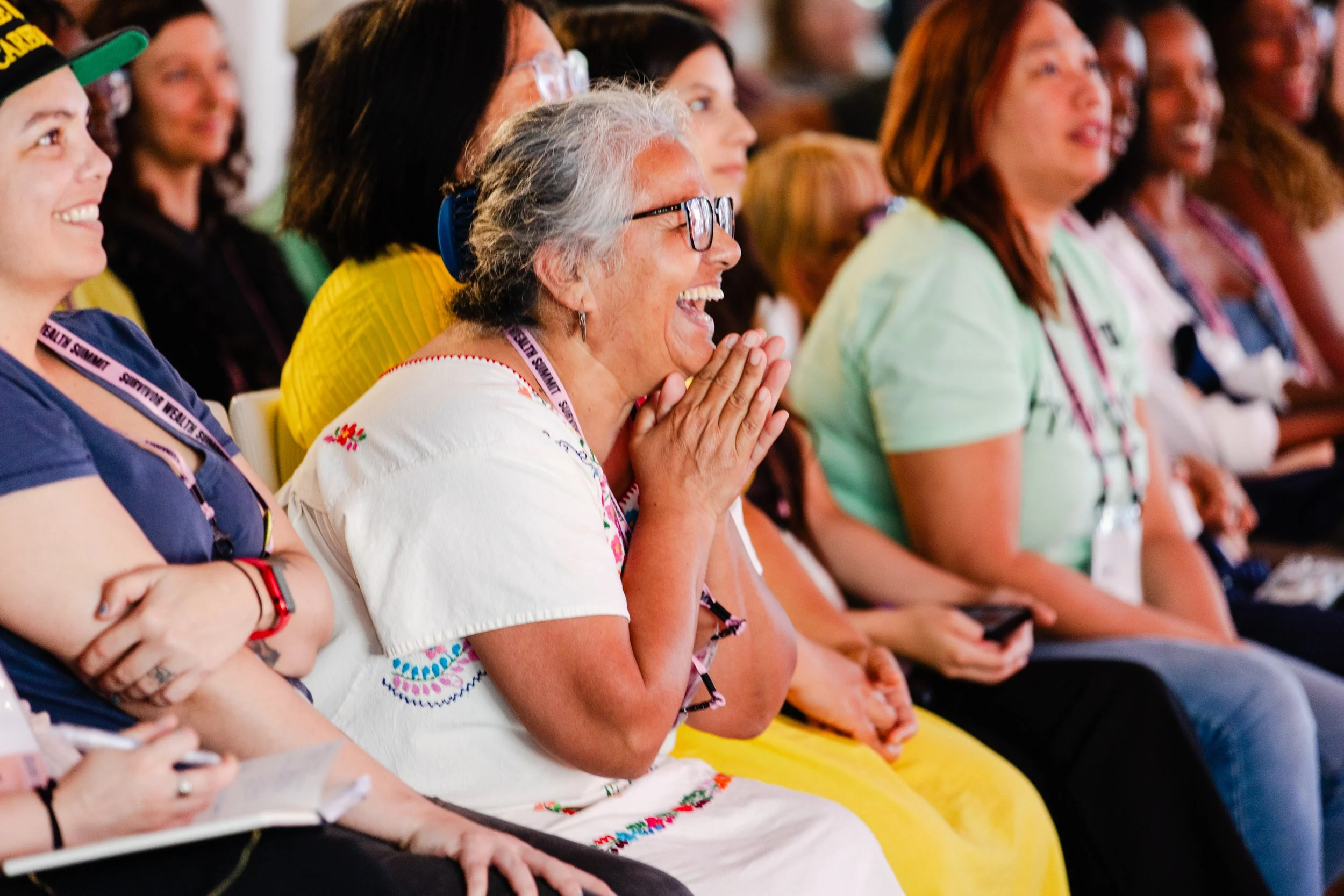 An audience member laughs during a keynote at a nonprofit event videoed by Solhaus Media