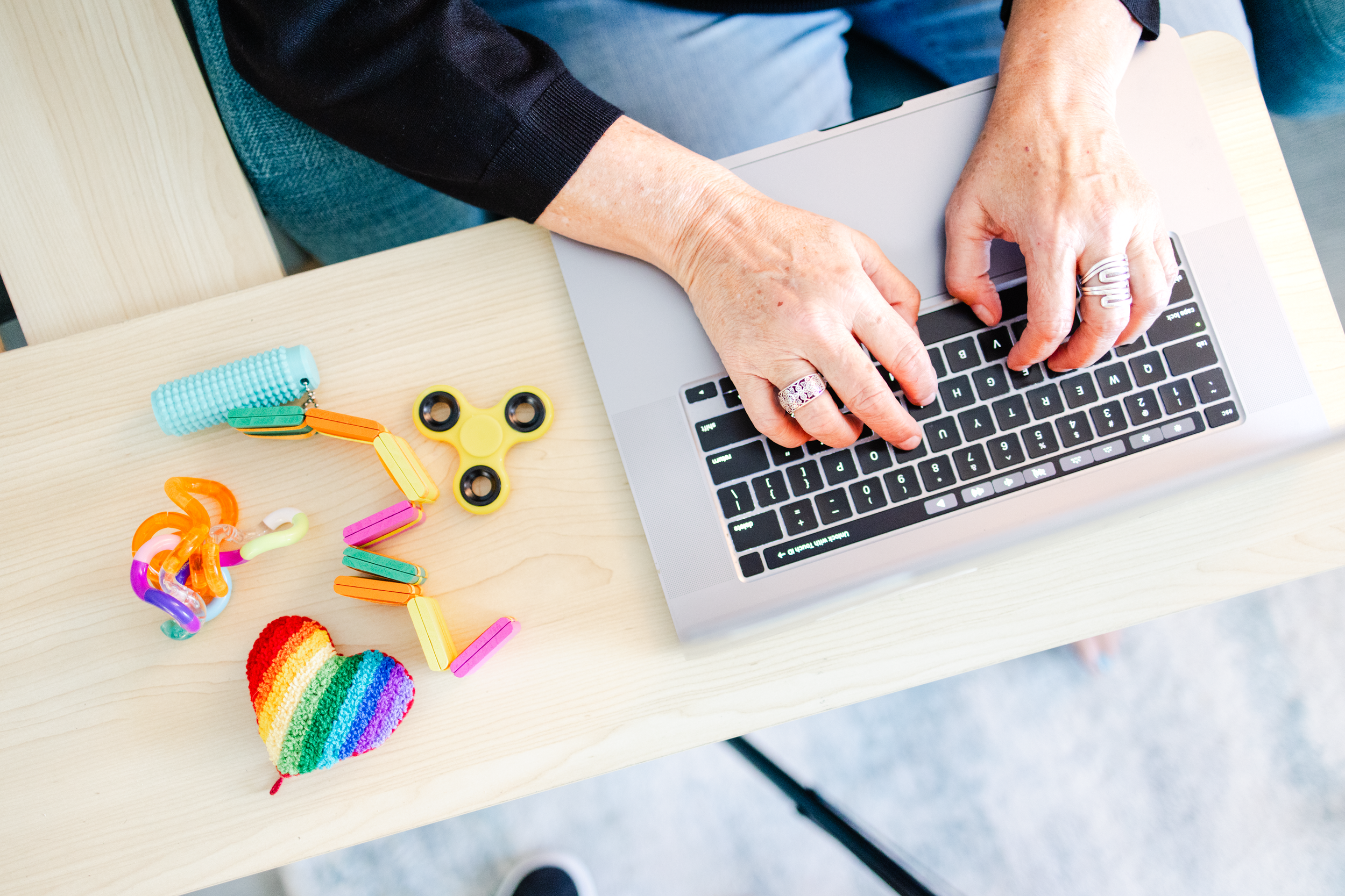 Overhead picture of hands on a laptop keyboard for a therapy business's brand photo session.
