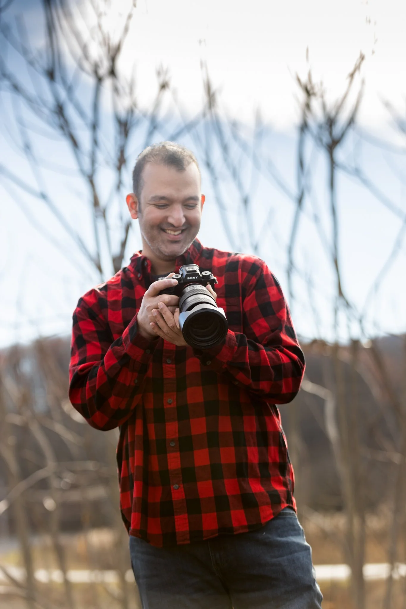 A male holds a a camera in this NJ branding photography session.