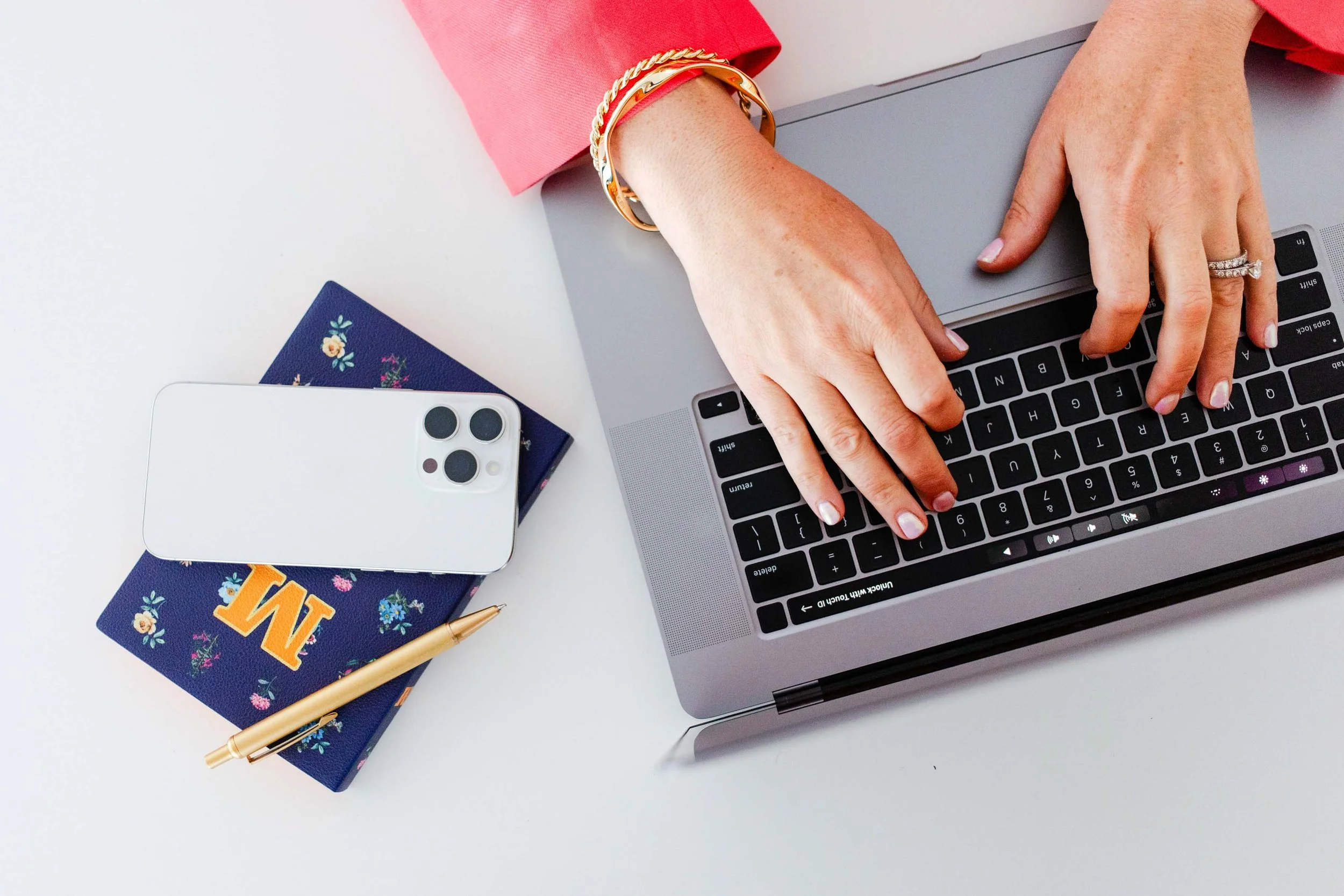 Flatlay of laptop, phone, and essential business props used during a New Jersey brand photoshoot