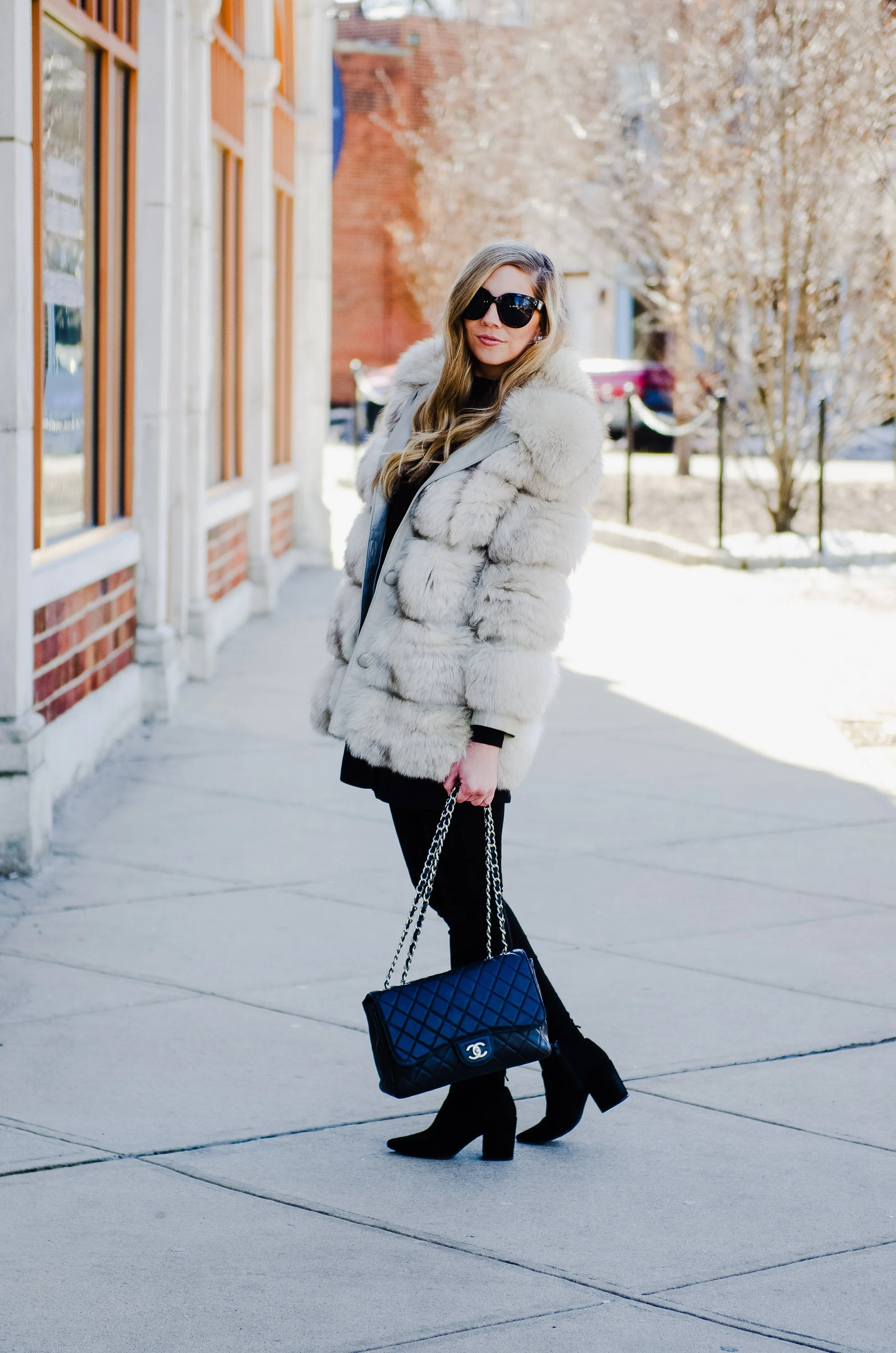 Brand portrait of woman in winter coat and sunglasses in Montclair