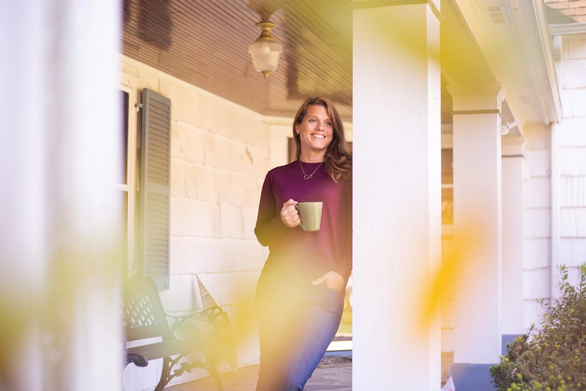 New Jersey brand photo of coach Amy Young of Redefine Possibility on her porch with a mug of coffee.