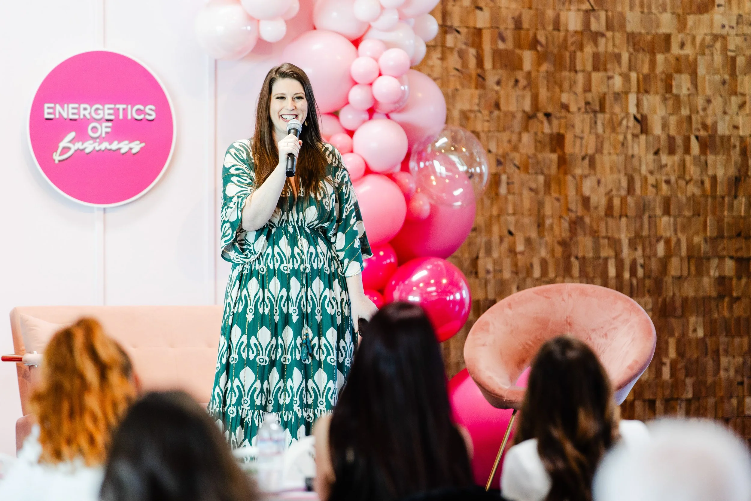 Woman speaking on stage at transformational women’s business event