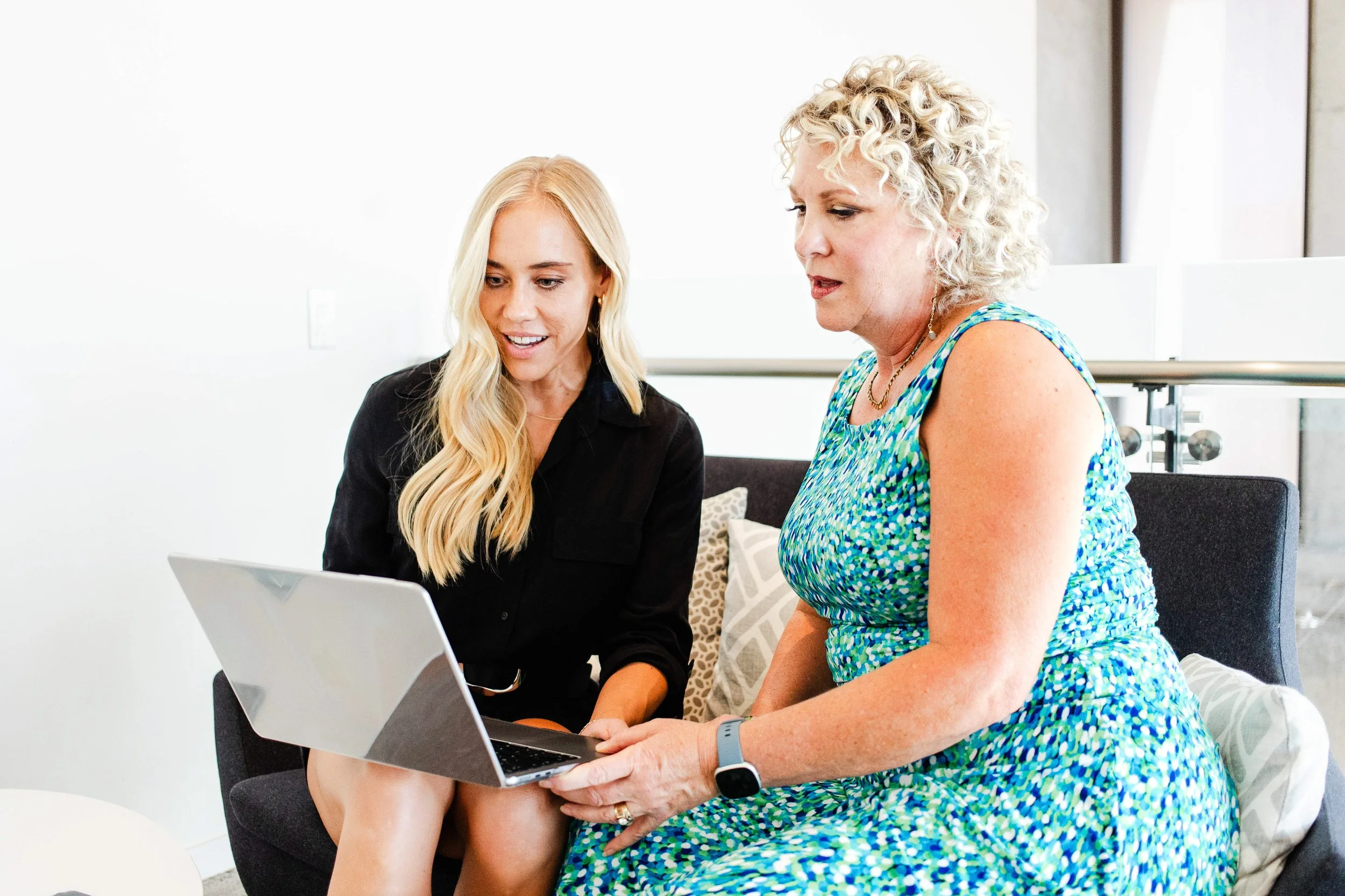 Women review materials on a laptop for a Los Angeles business branding session
