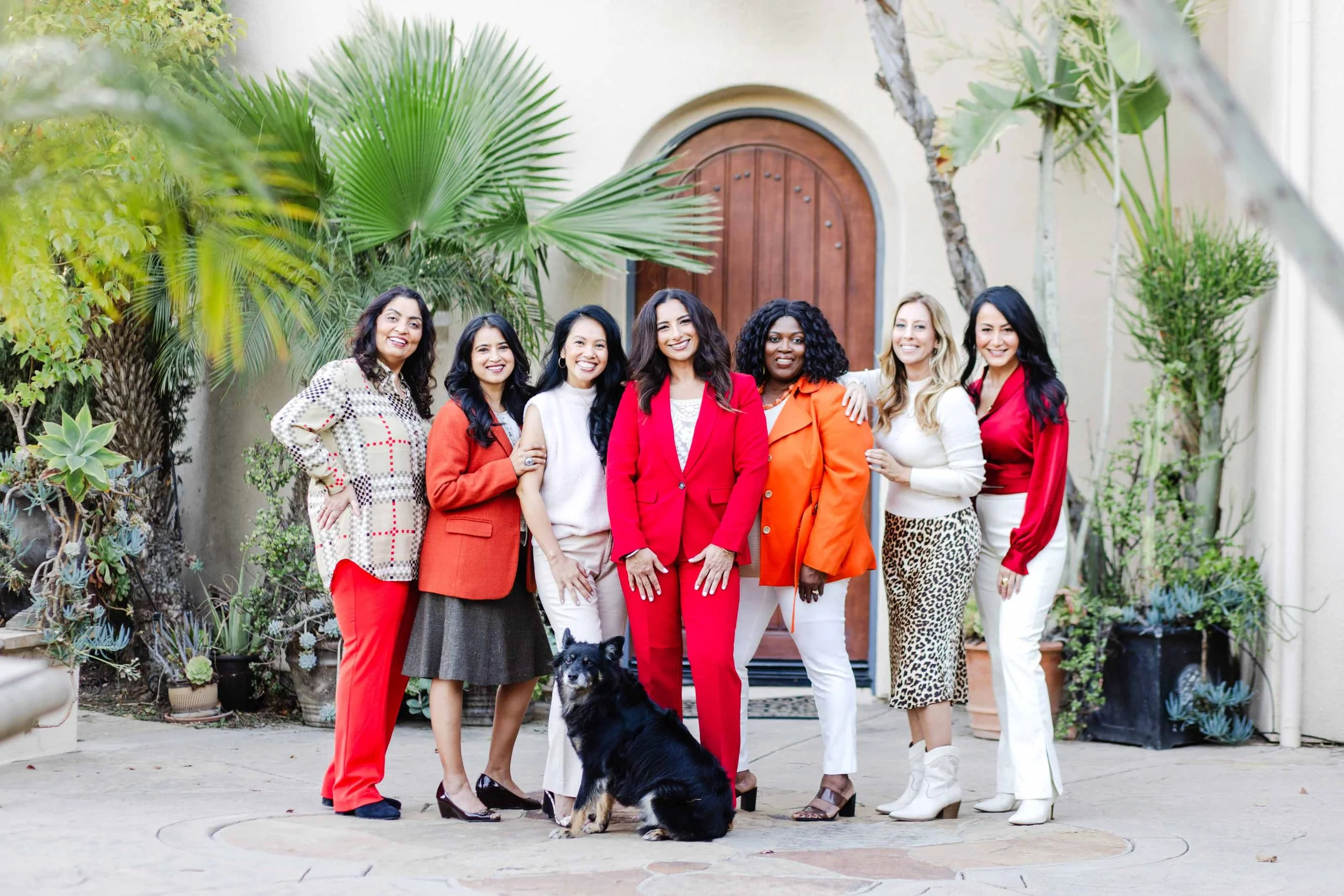 Group of women posing together outside a light-filled building as part of a North Jersey brand photoshoot session