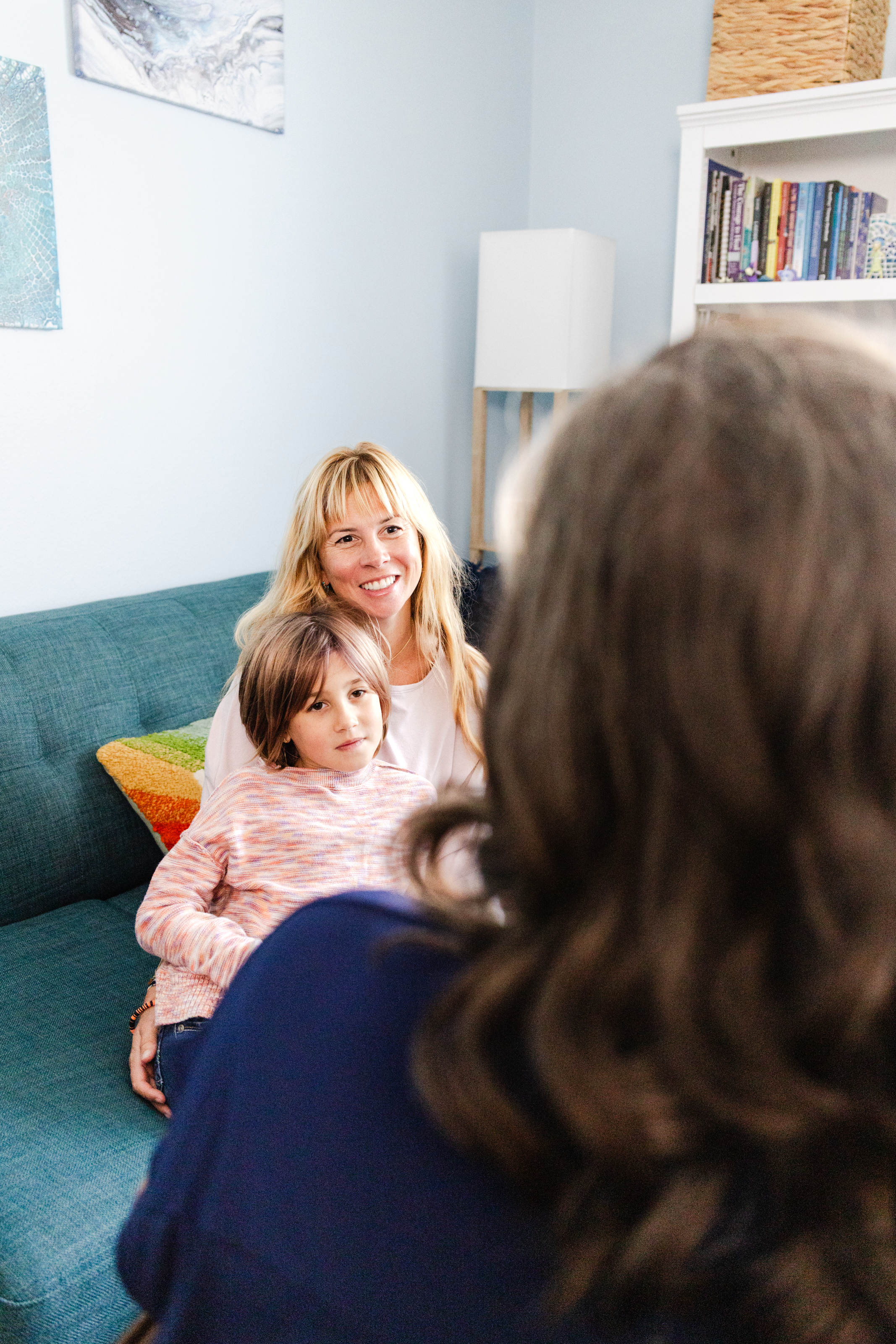 An over-the-shoulder shot of a therapist speaking to her clients for a brand photography session.