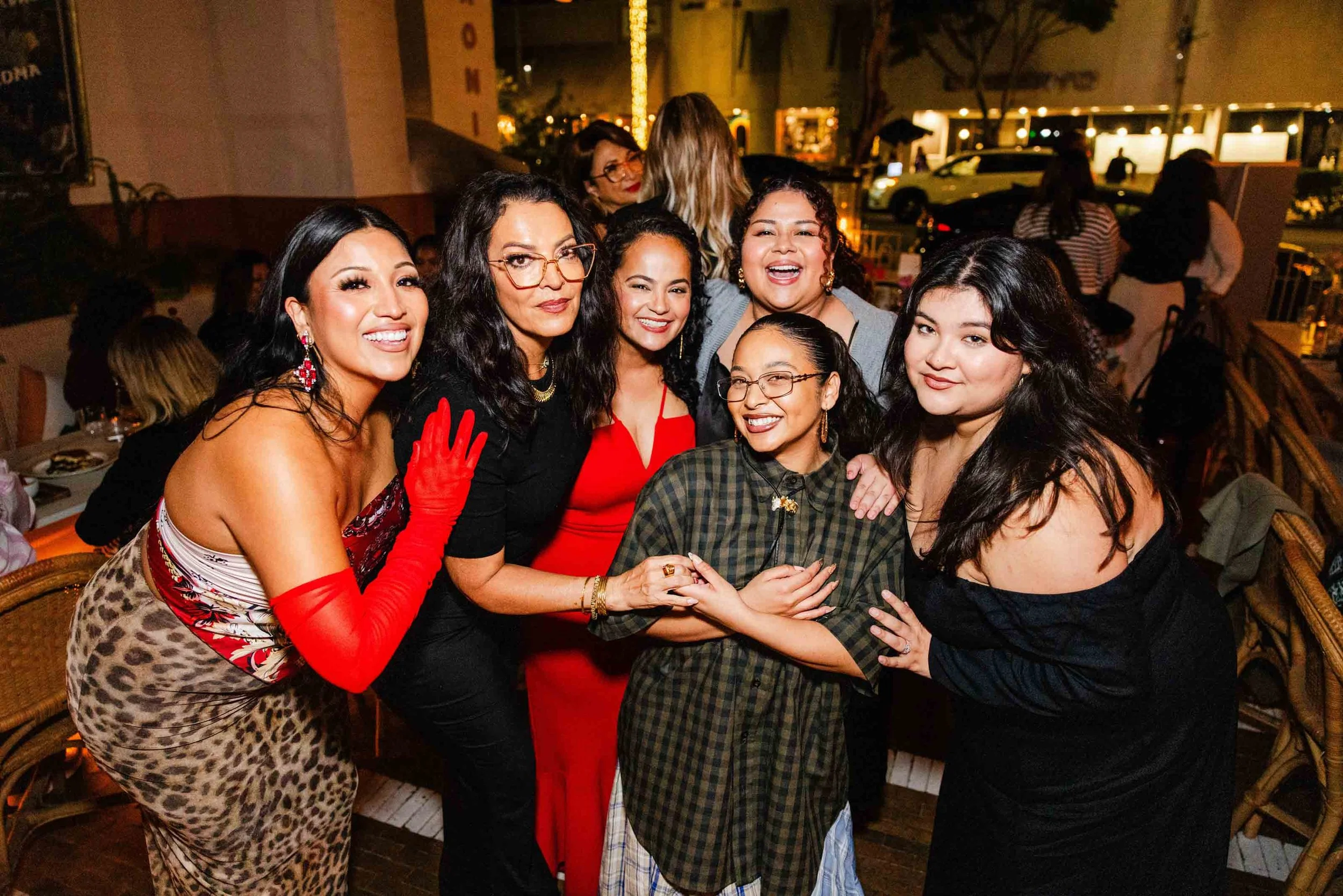 A group of attendees, including Latinas in Beauty speakers and guests, pose for a joyful photo at the Beverly Hills launch event.