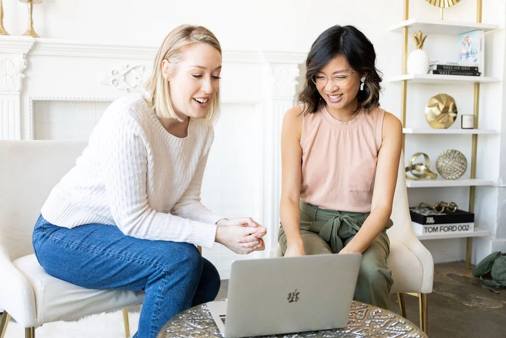 Brand photographer reviewing images with client during a personal brand photoshoot planning session in Los Angeles