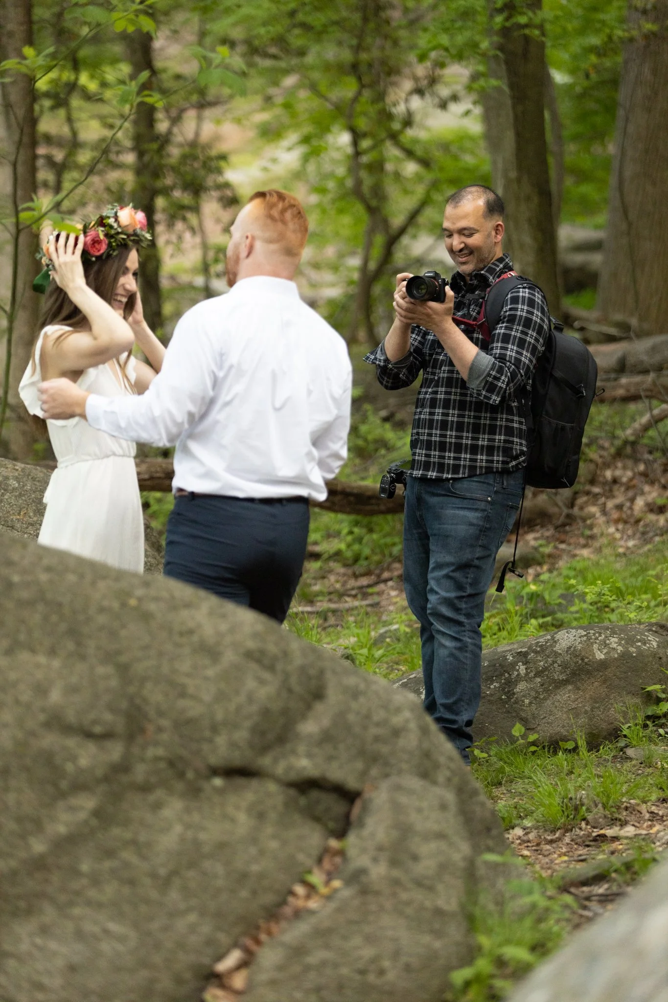 A male photographer takes pictures of a wedding couple in this NJ branding photography session.