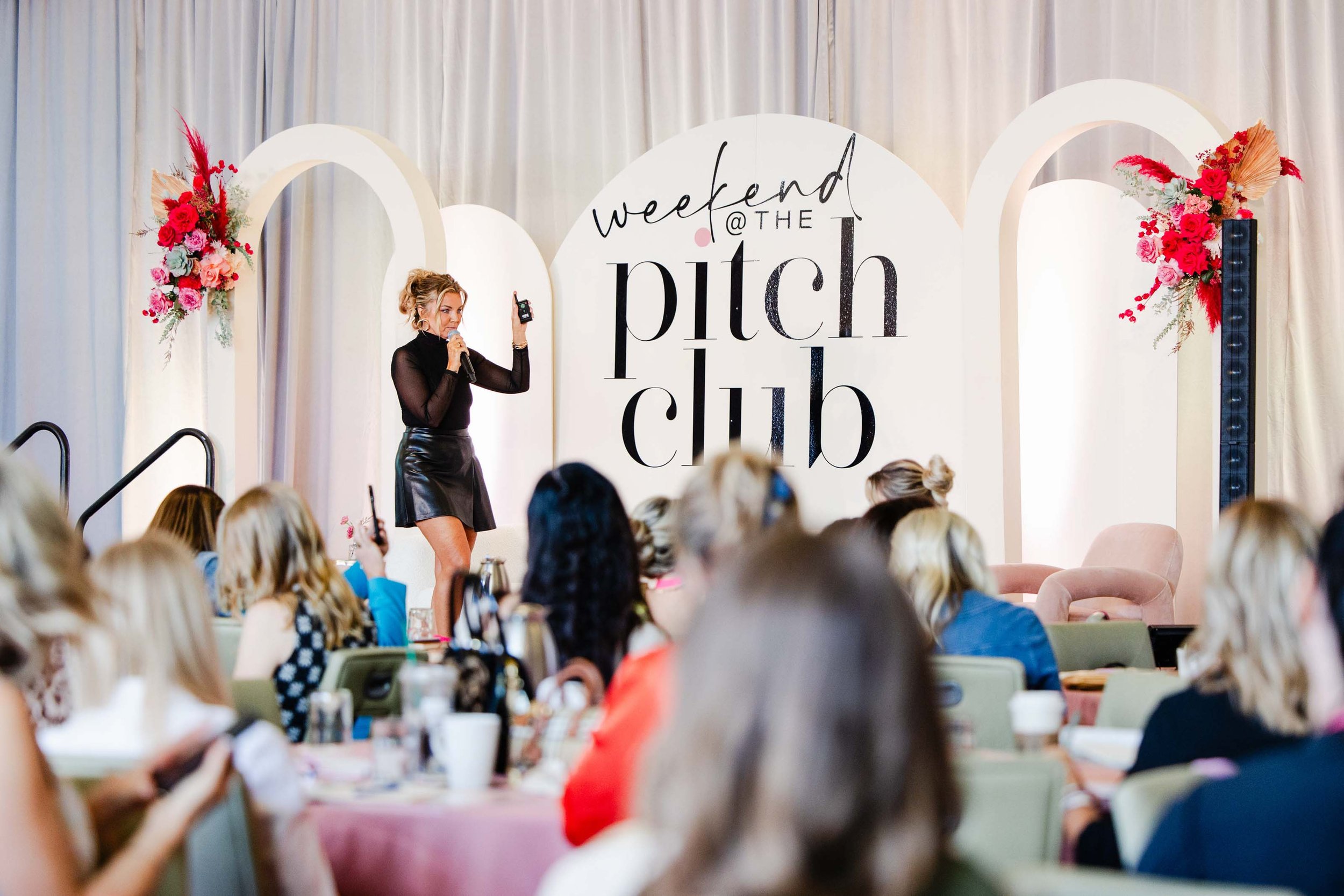 Tracy O’Malley mid-presentation during a keynote speech on leadership and personal growth.