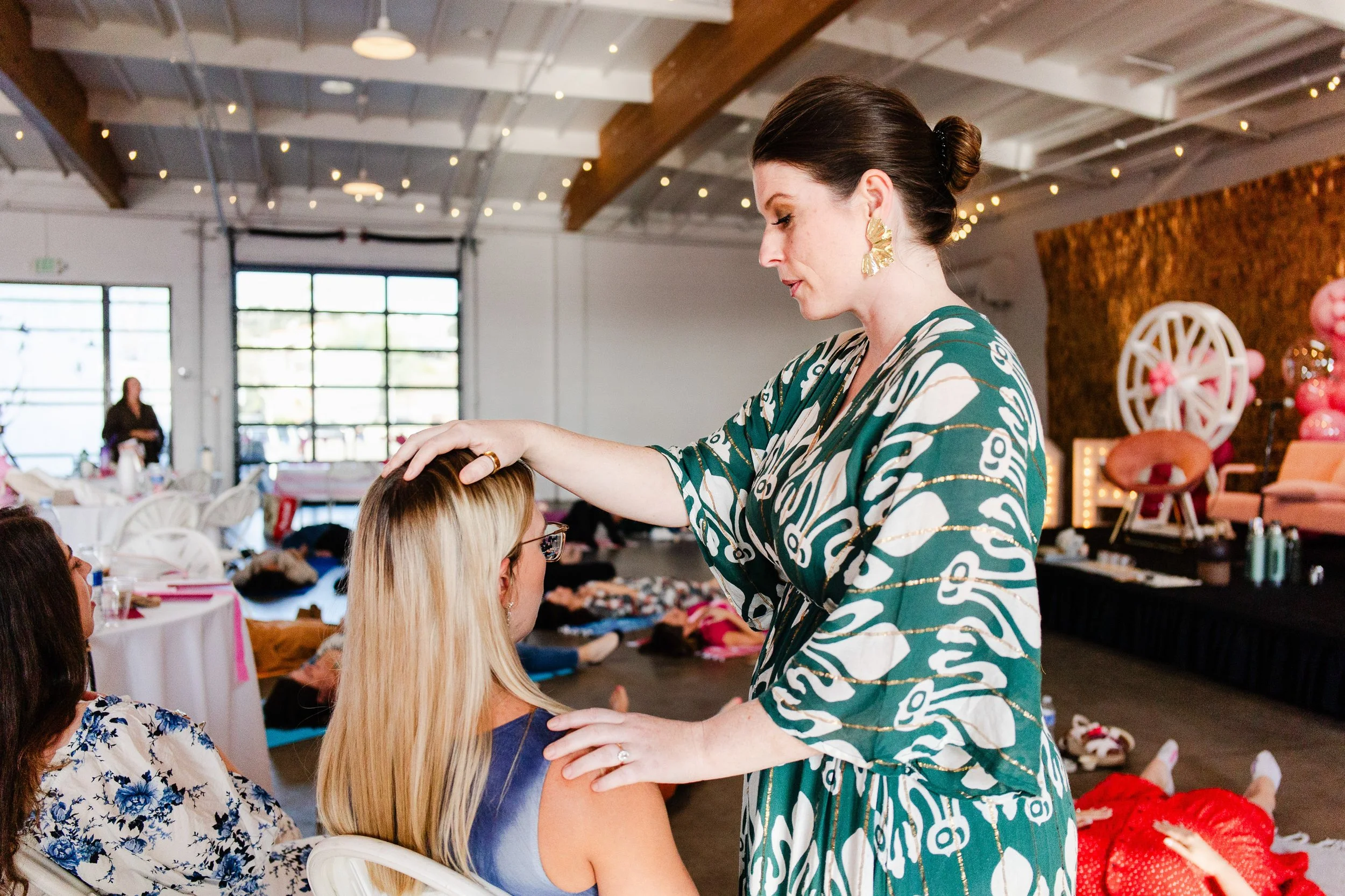 Woman receiving energy healing during a transformational business and wellness retreat event