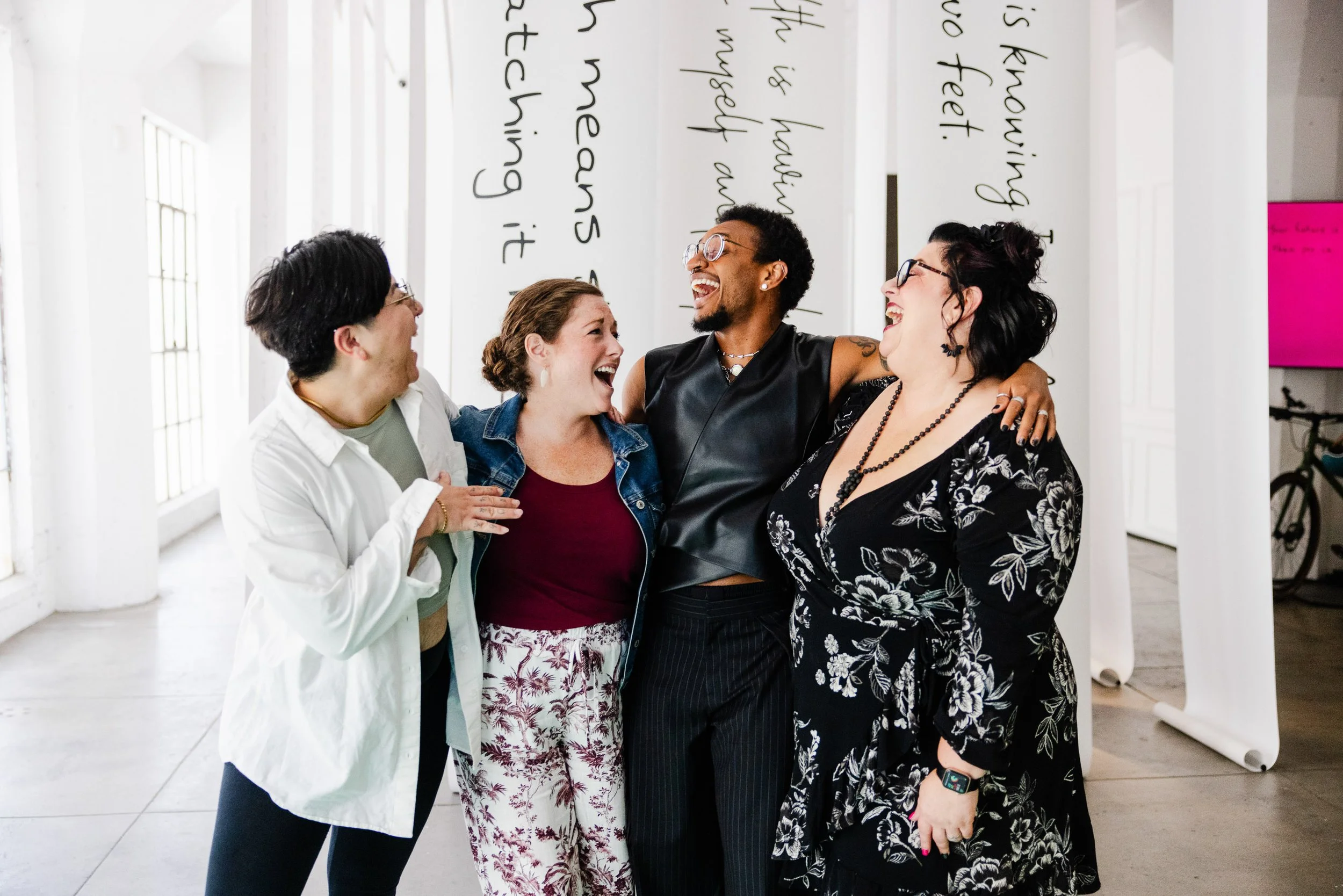 A mixed group of folx embracing at the Survivor Wealth Summit nonprofit event in downtown Los Angeles