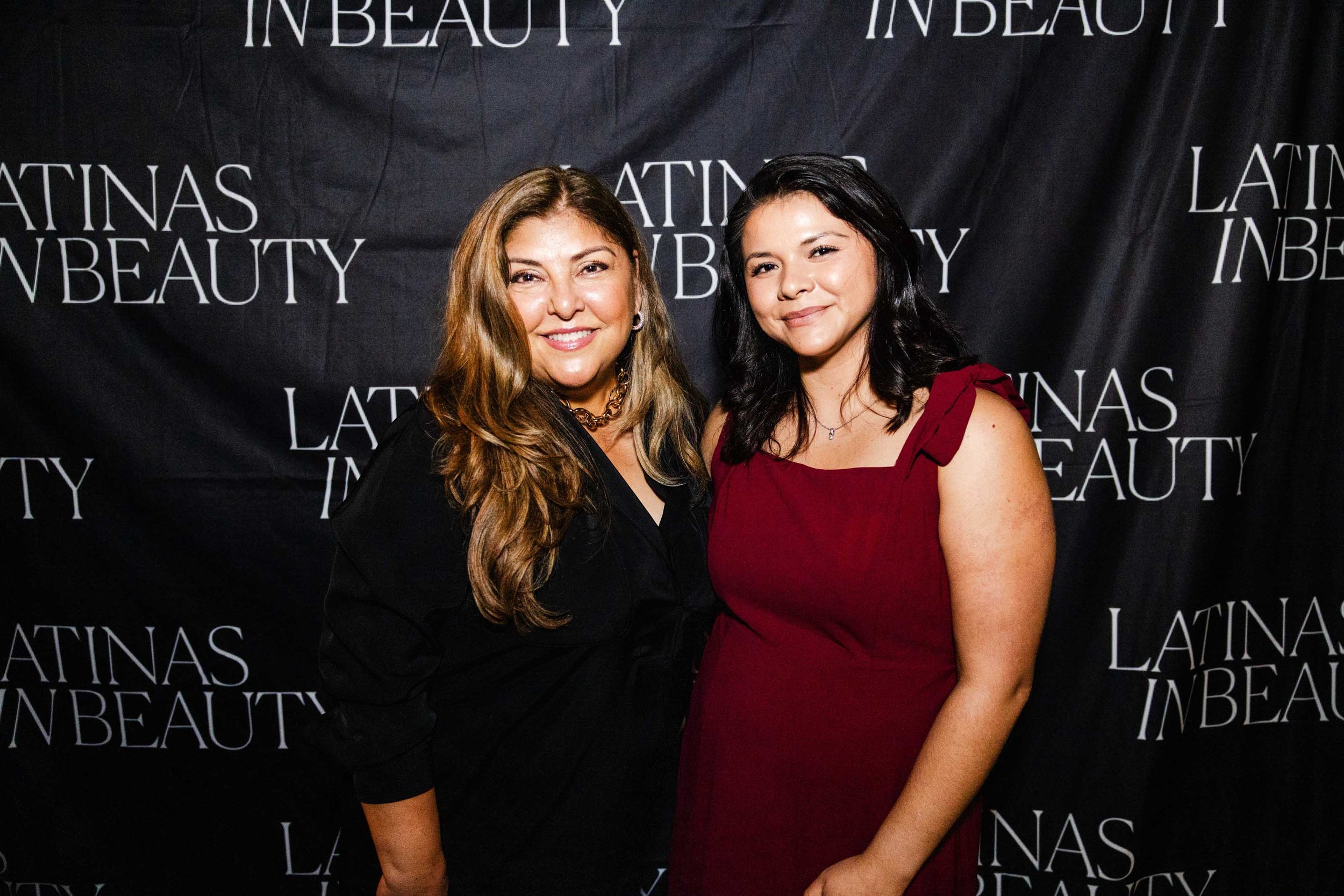 Two women pose together at the Latinas in Beauty step-and-repeat, captured during a professional Los Angeles event photography session.