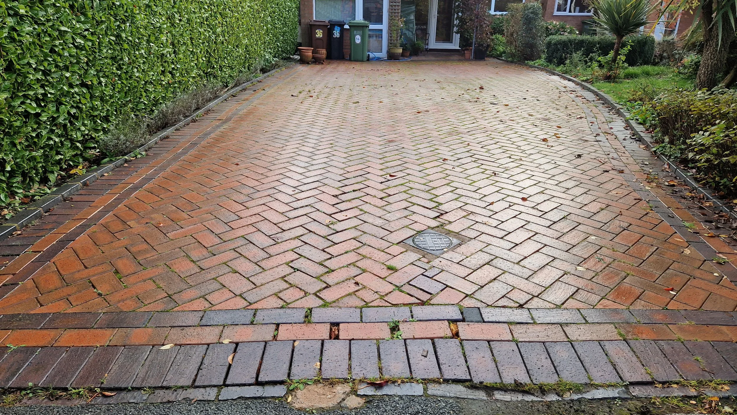 Full restoration of a clay block paved driveway that was 15 years old. SRS lifted and relayed damaged sunken sections, re-laid the border pavers. pressure washed and re-sanded & installed a new tarmac strip.