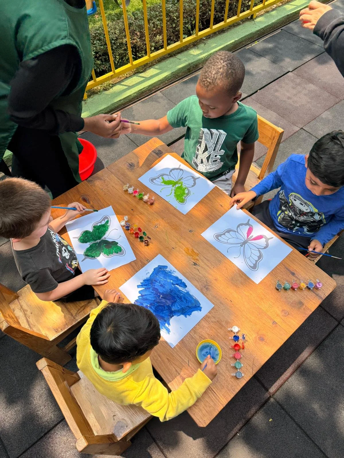 kids at table painting.jpeg