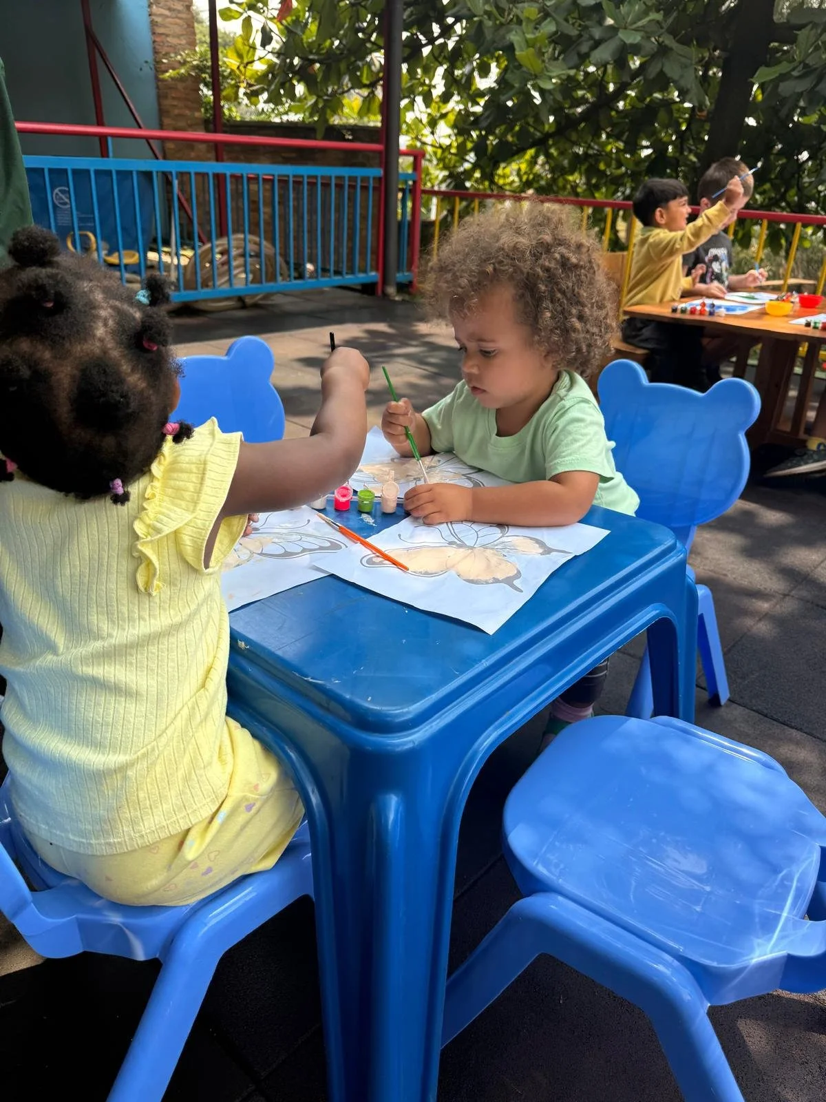 nini at table painting.jpeg