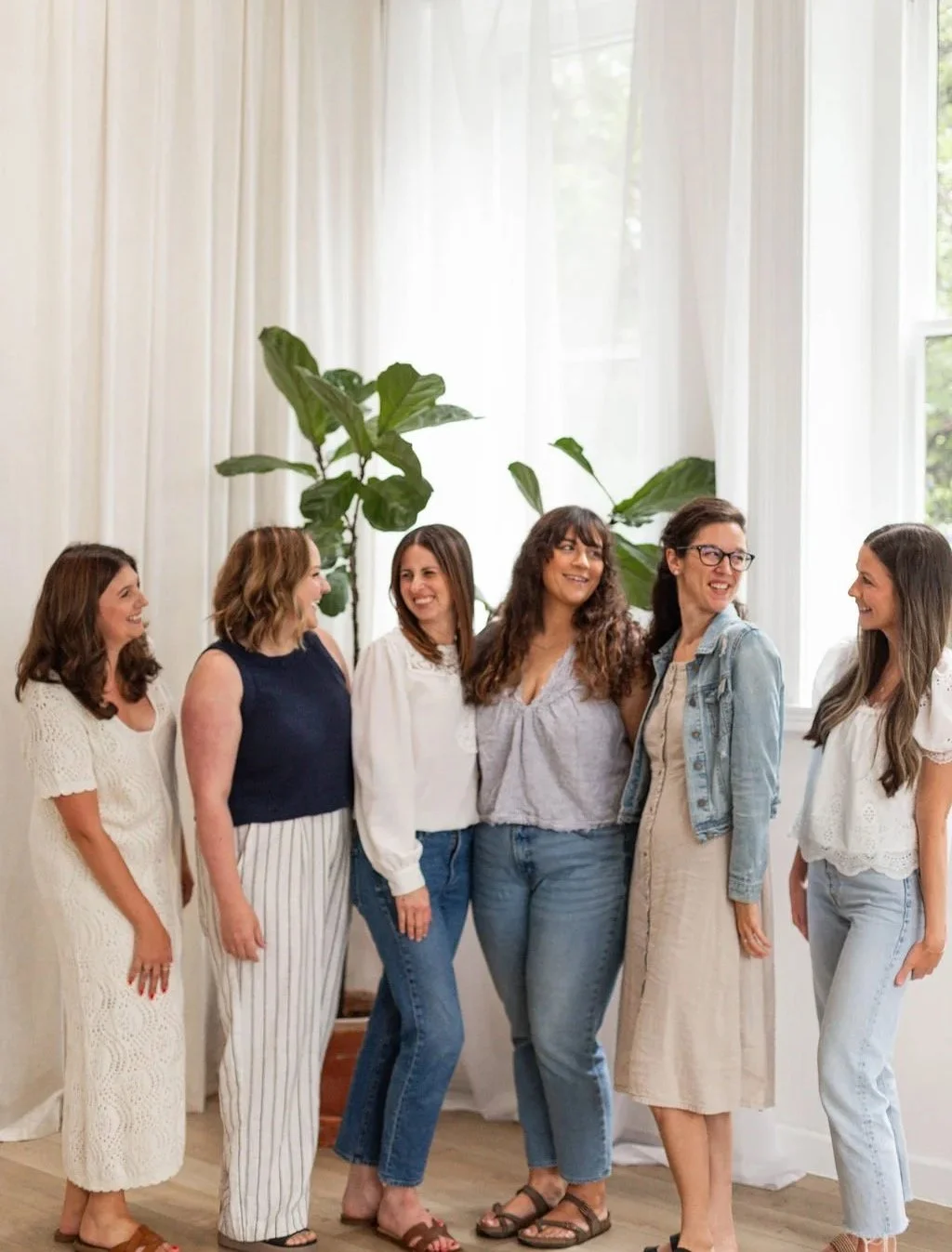 Thrive Doula Services team of birth and postpartum doulas serving Columbus, Ohio, smiling together in a bright studio setting