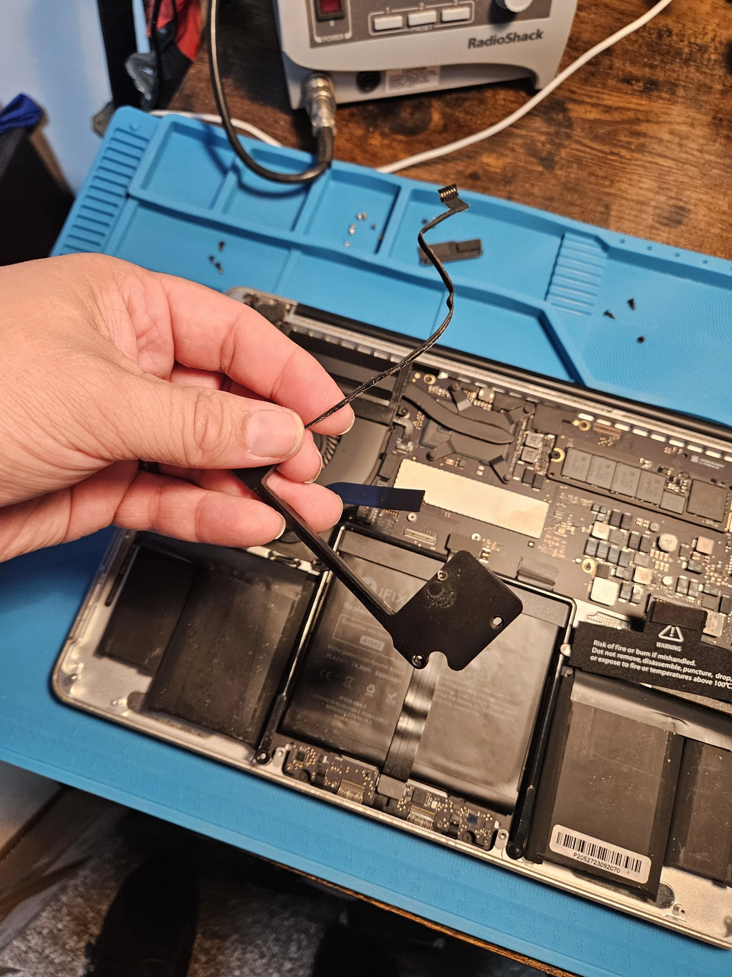 Removing the speakers to make way for the new ones. If it was just a battery replacement only I would have kept them in place and worked around them.