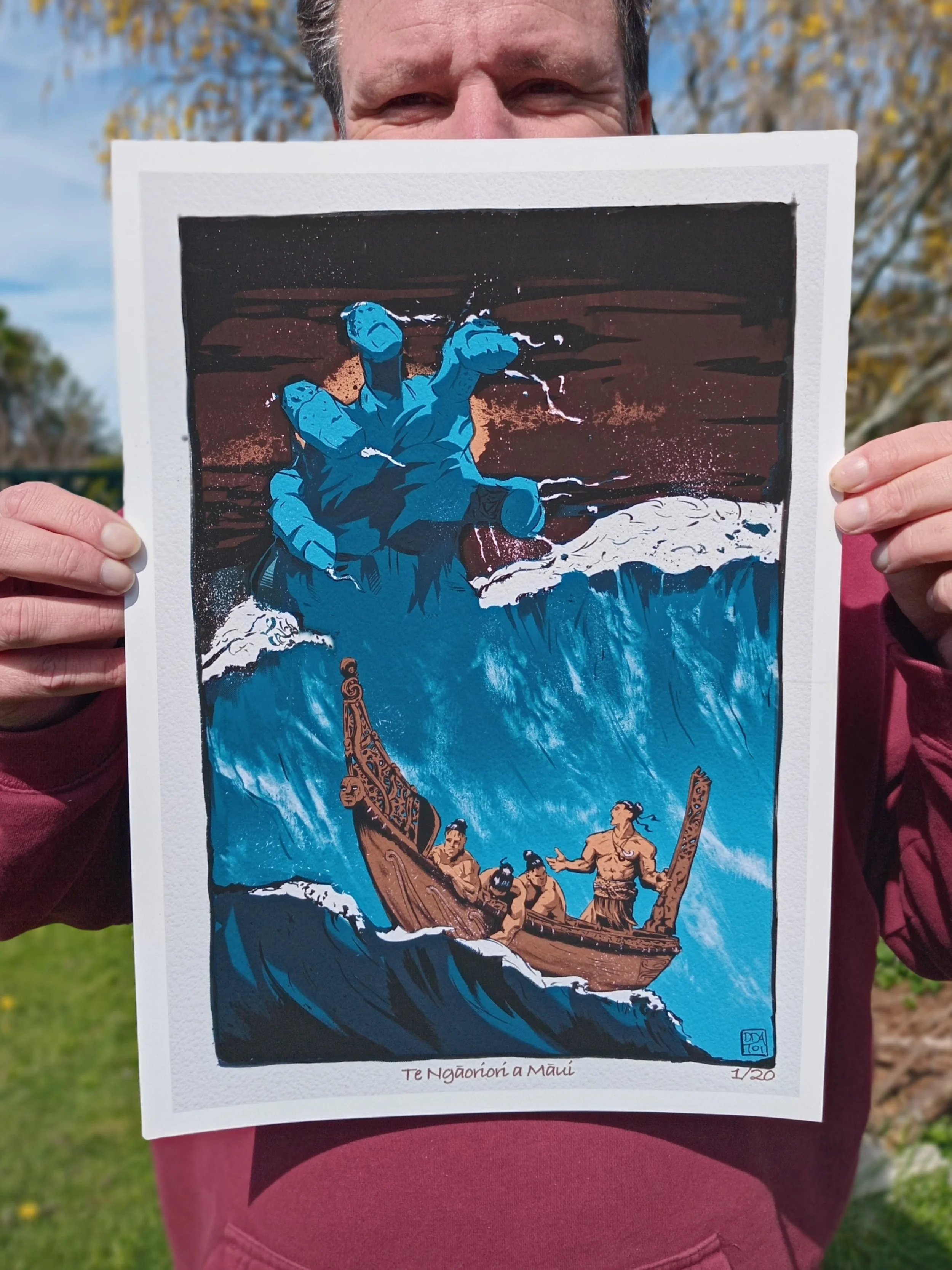 Artist Daniel Allen holding the Te Ngaoriori a Māui limited edition Māori art print