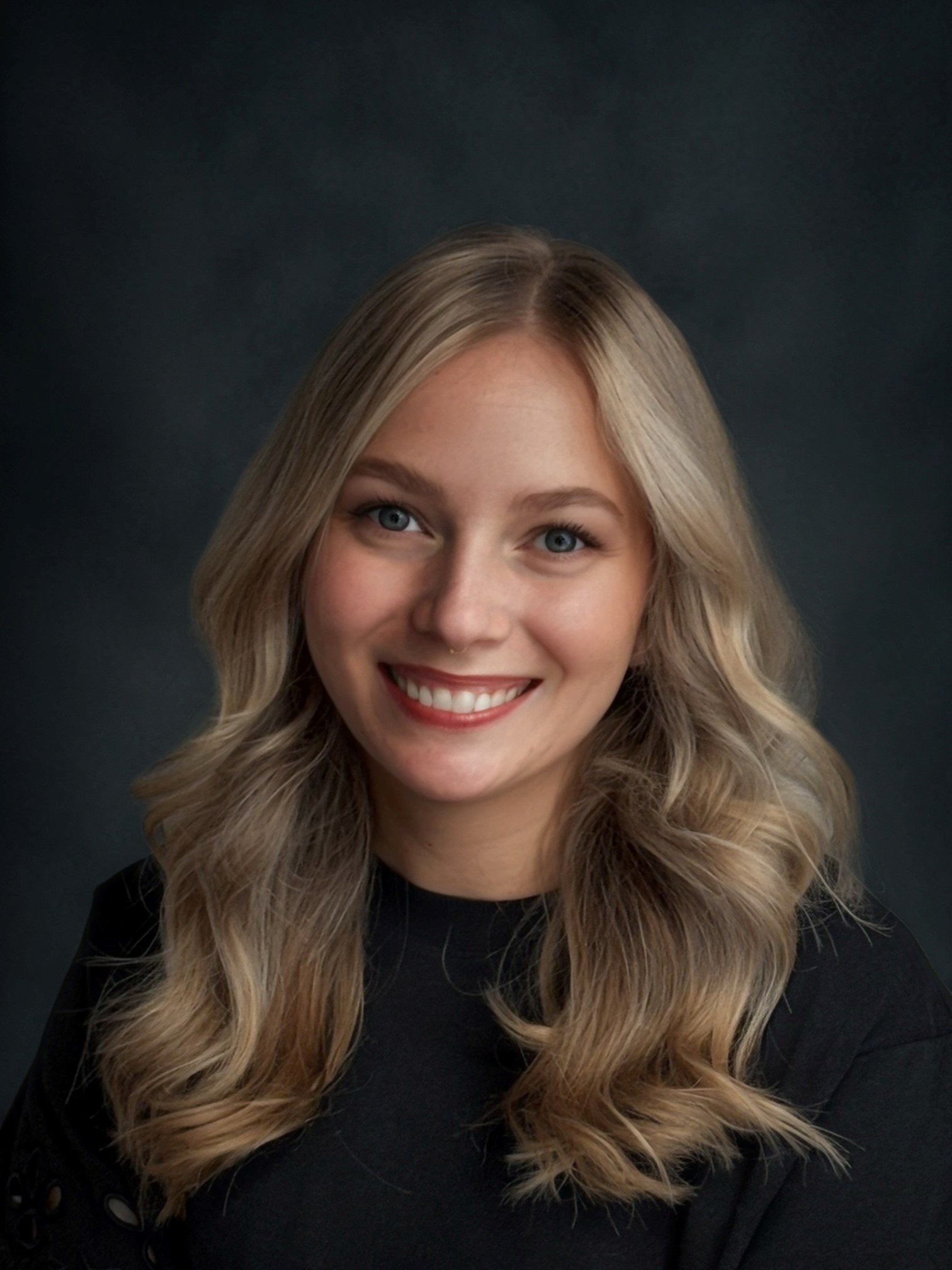 Headshot of caucasian woman with blonde hair smiling