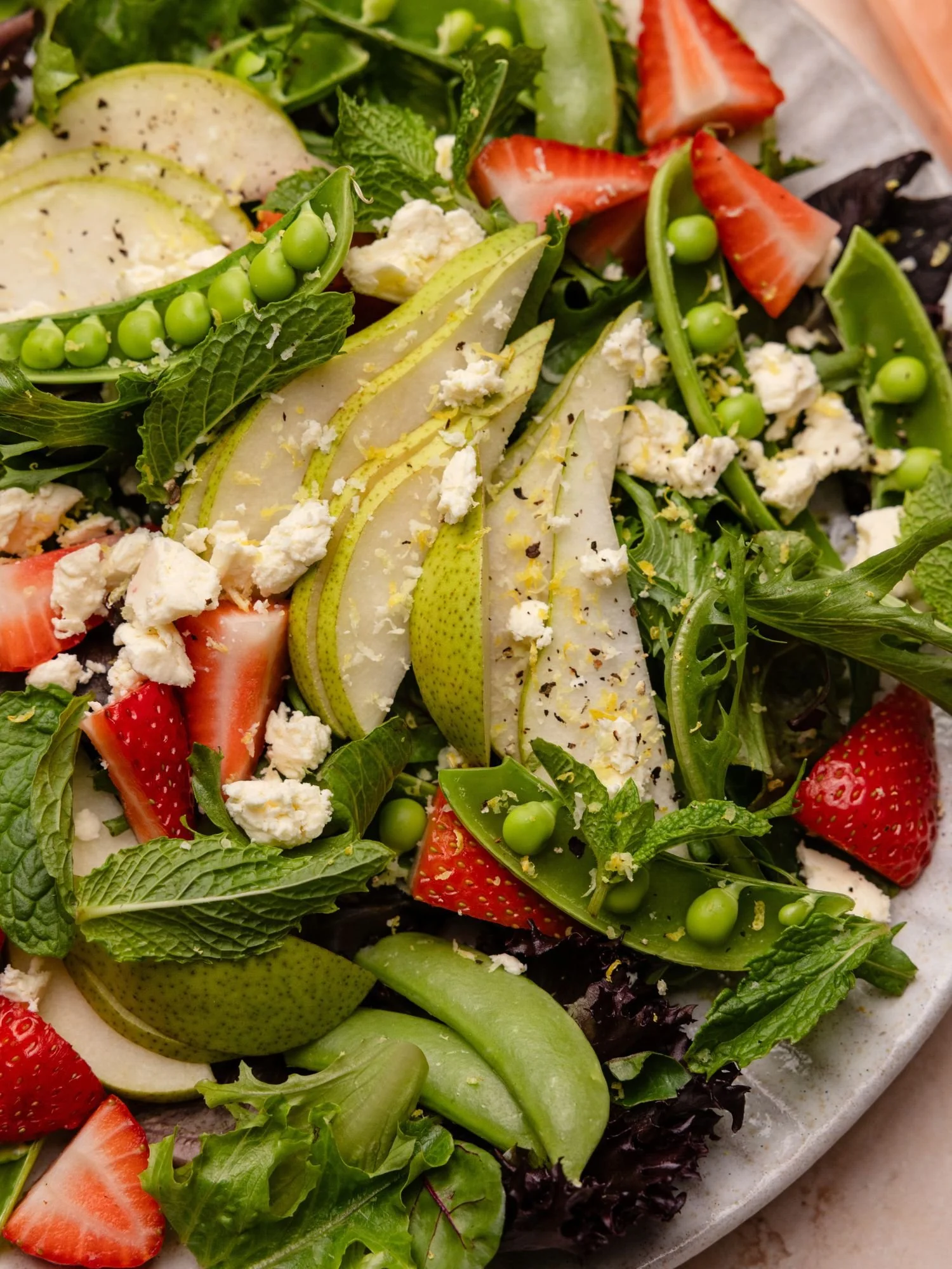 Fresh Australian pear salad with strawberries, mint and peas