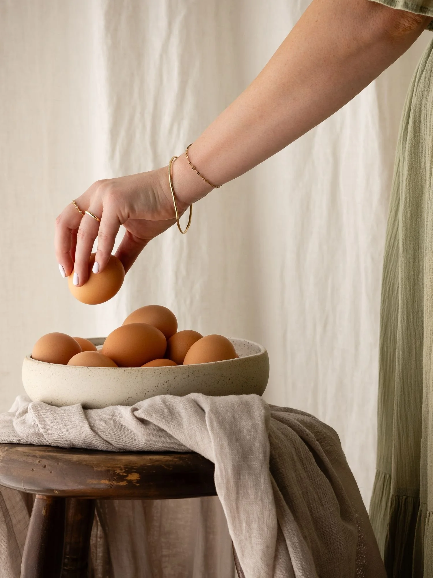Hands grabbing eggs from bowl, Australian Eggs