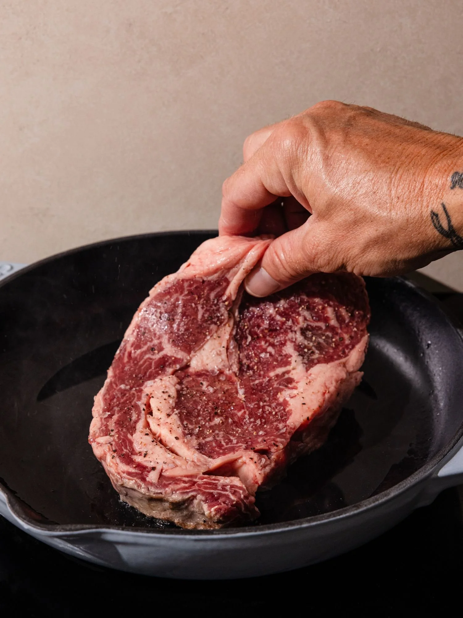 Raw steak from MOJ’s placed into frying pan