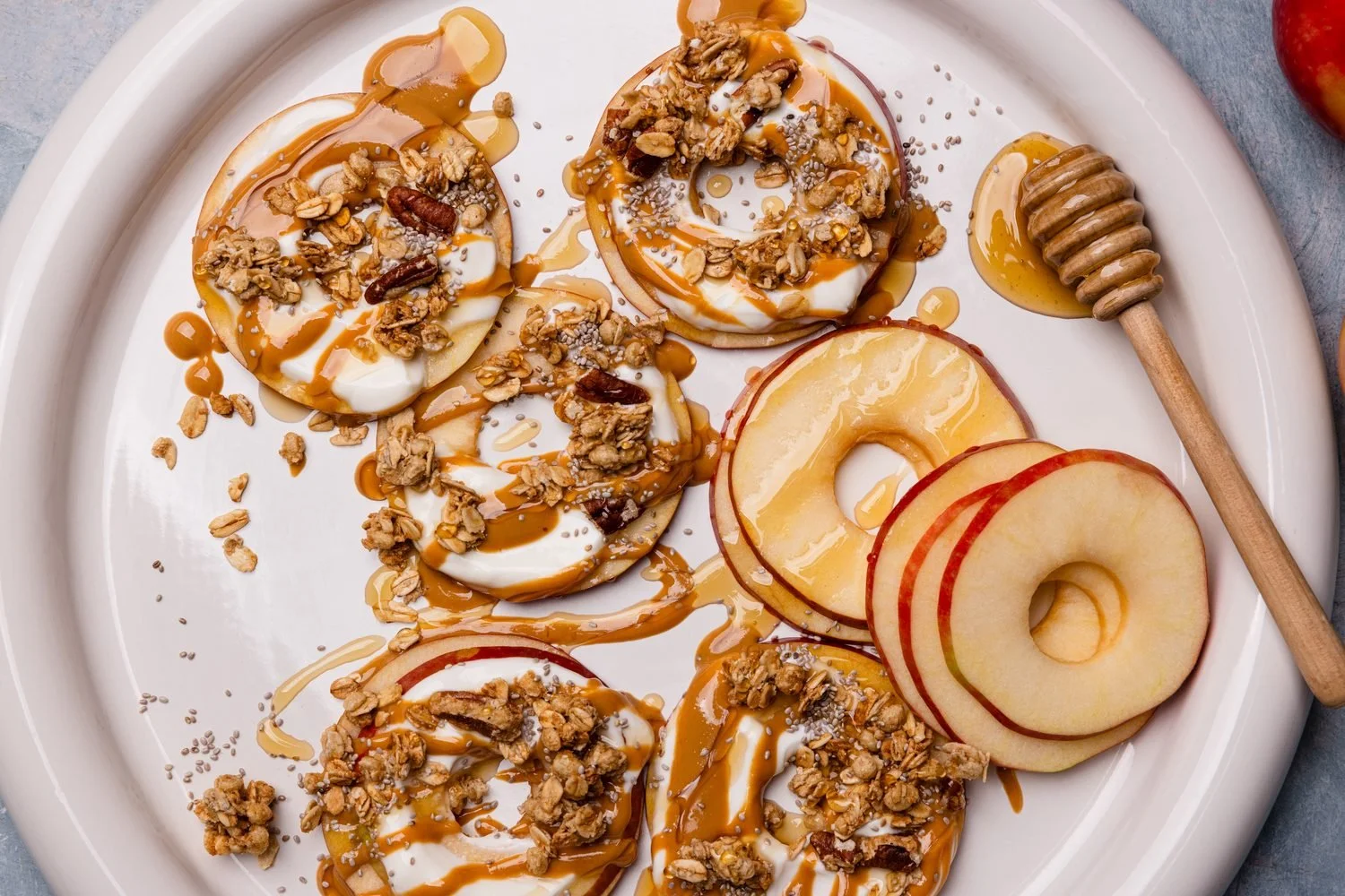 Apple bagels topped with nut butter, granola and honey