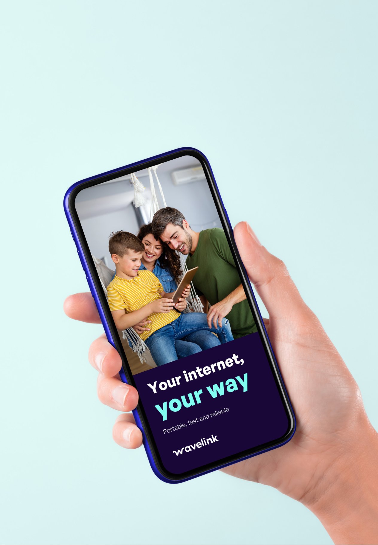 A hand holding a smartphone displaying an advertisement with a happy family of three looking at a tablet together. The advertisement promotes internet service with text 'Your internet, your way' and 'Portable, fast and reliable' by Wavelink.