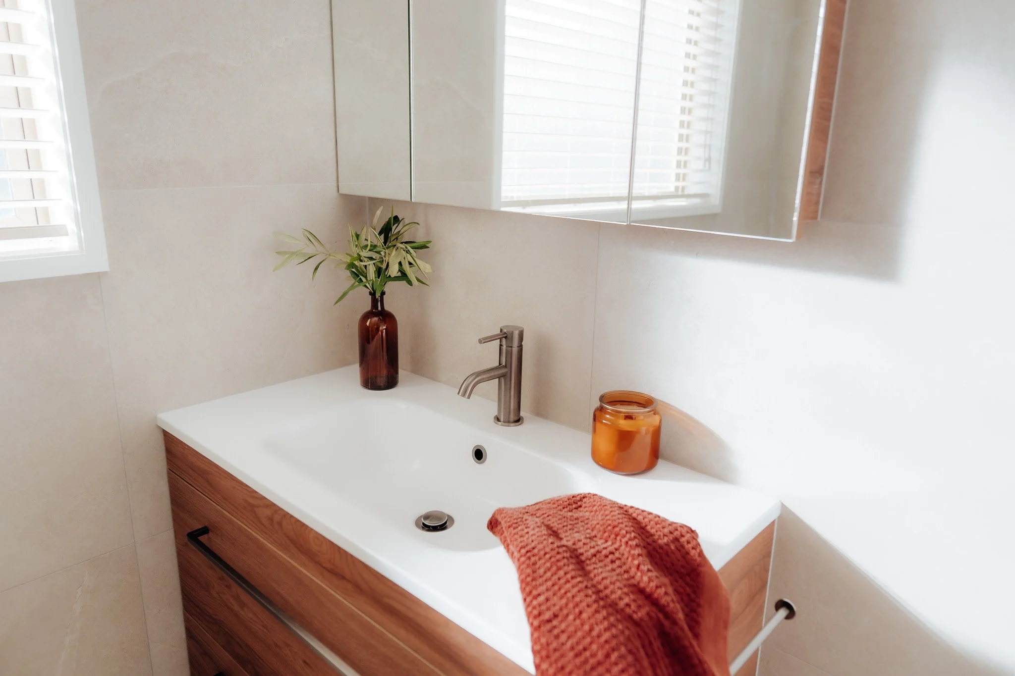 This beautifully renovated ensuite features a harmonious blend of warm tones and contemporary design elements, creating a serene retreat right at home. From the inviting beige hues to the sleek gunmetal fixtures, every detail has been thoughtfully ch