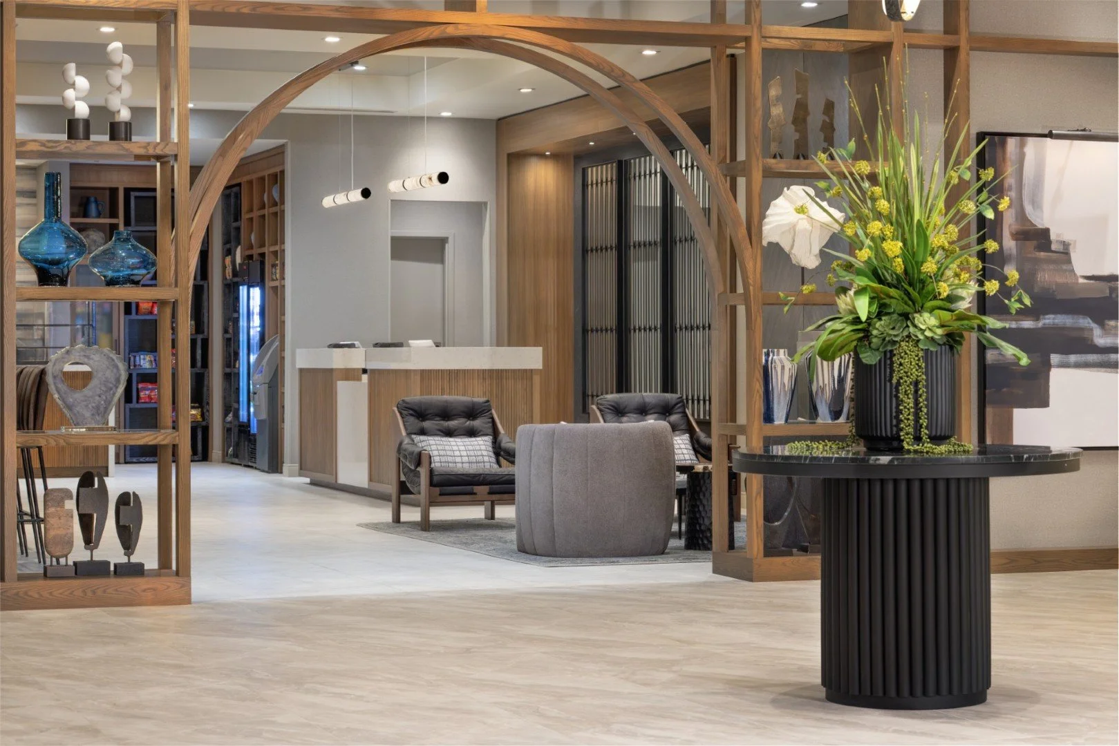 A modern hotel lobby with seating area, fireplace, and reception desk, marked with a large overlay text reading 'Photo Coming Soon'.