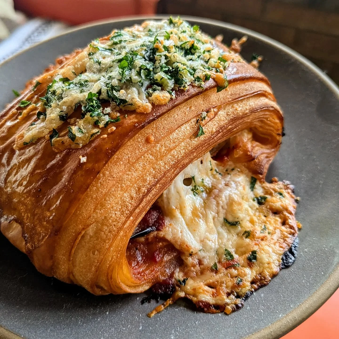 Let's call this an &quot;aubergine parmigiana pain suisse&quot;. Roasted aubergine, marinara, and mozzarella wrapped up in croissant pastry and topped with parmesan and parsley. New bakeday menu coming really soon 😭😭😭

#sundaybakeday #laminateddou