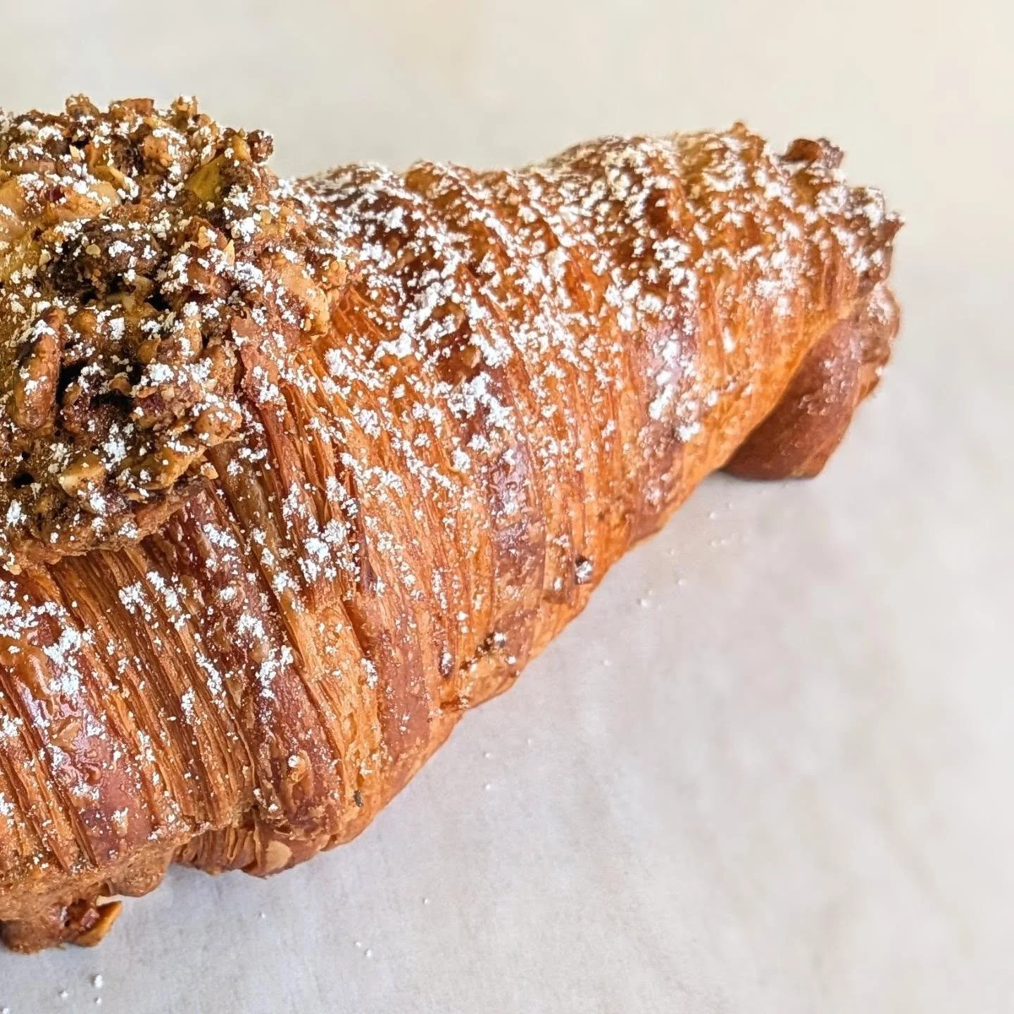 It's time for my big bi-monthly content drop. This is a twice-baked pistachio "baklava" croissant. It gets dipped in a honey orange syrup and then filled with a frangipane made from pistachios, butter, eggs, sugar, and a load of orange zest